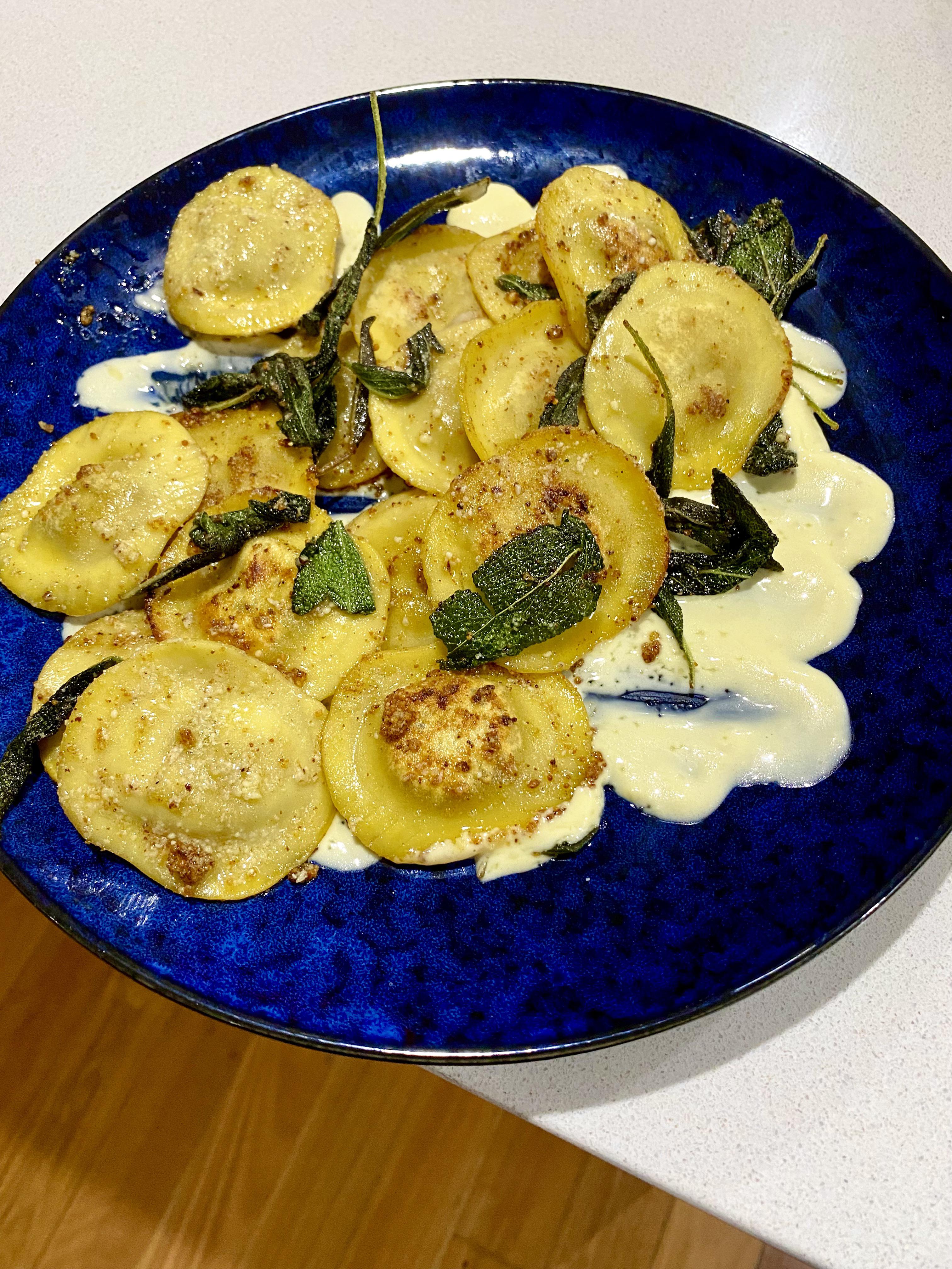 Parmesan crusted porcini mushroom ravioli on a garlic cream sauce base