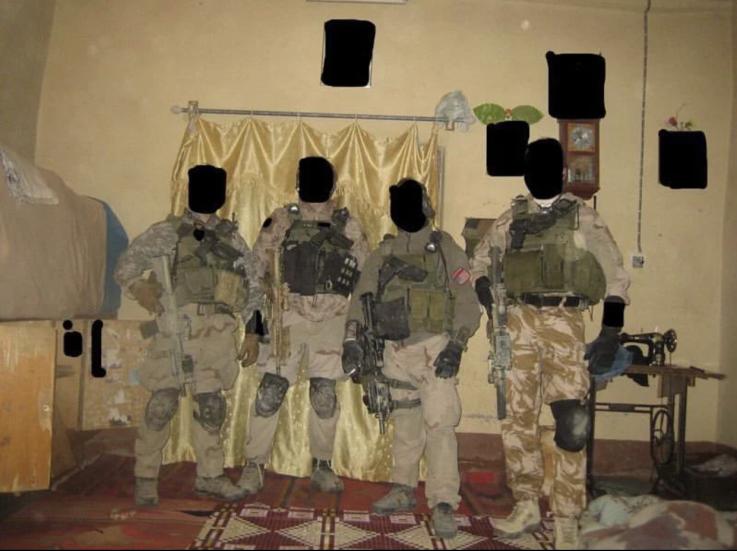 SAS and SBS operators from Task Force Black pose for a photograph in Iraq after a raid. r