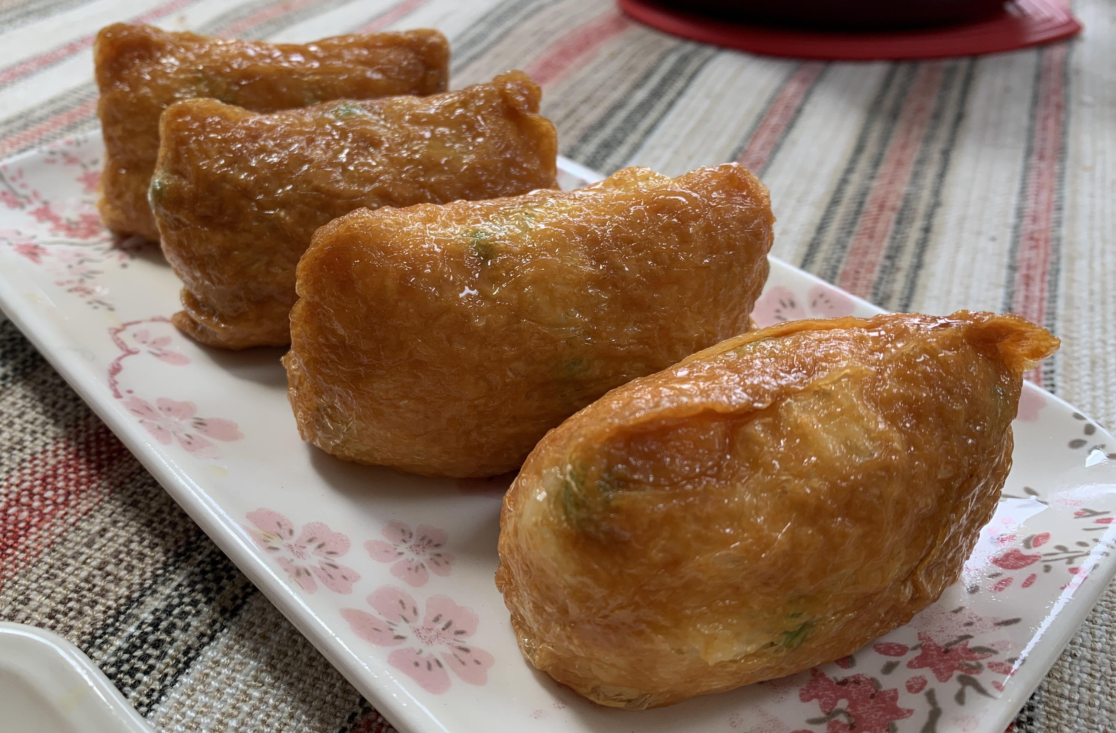 Fill inari with rice, corn, wilted spinach, edamame, broccoli, etc. and