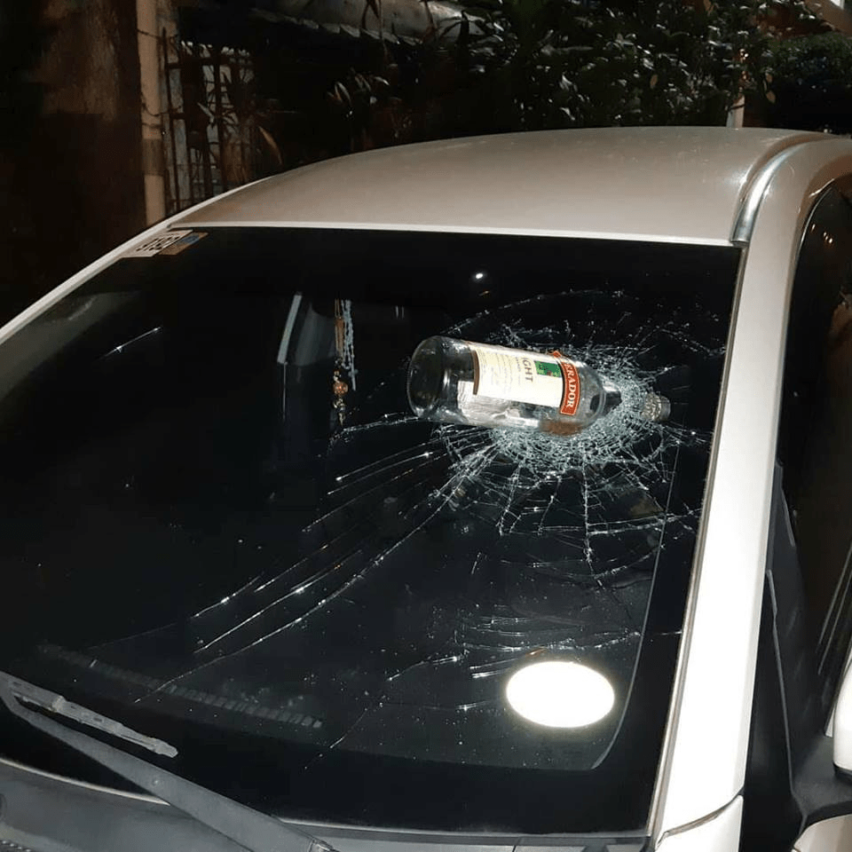 Someone threw a bottle at my neighbor's car while he was driving last