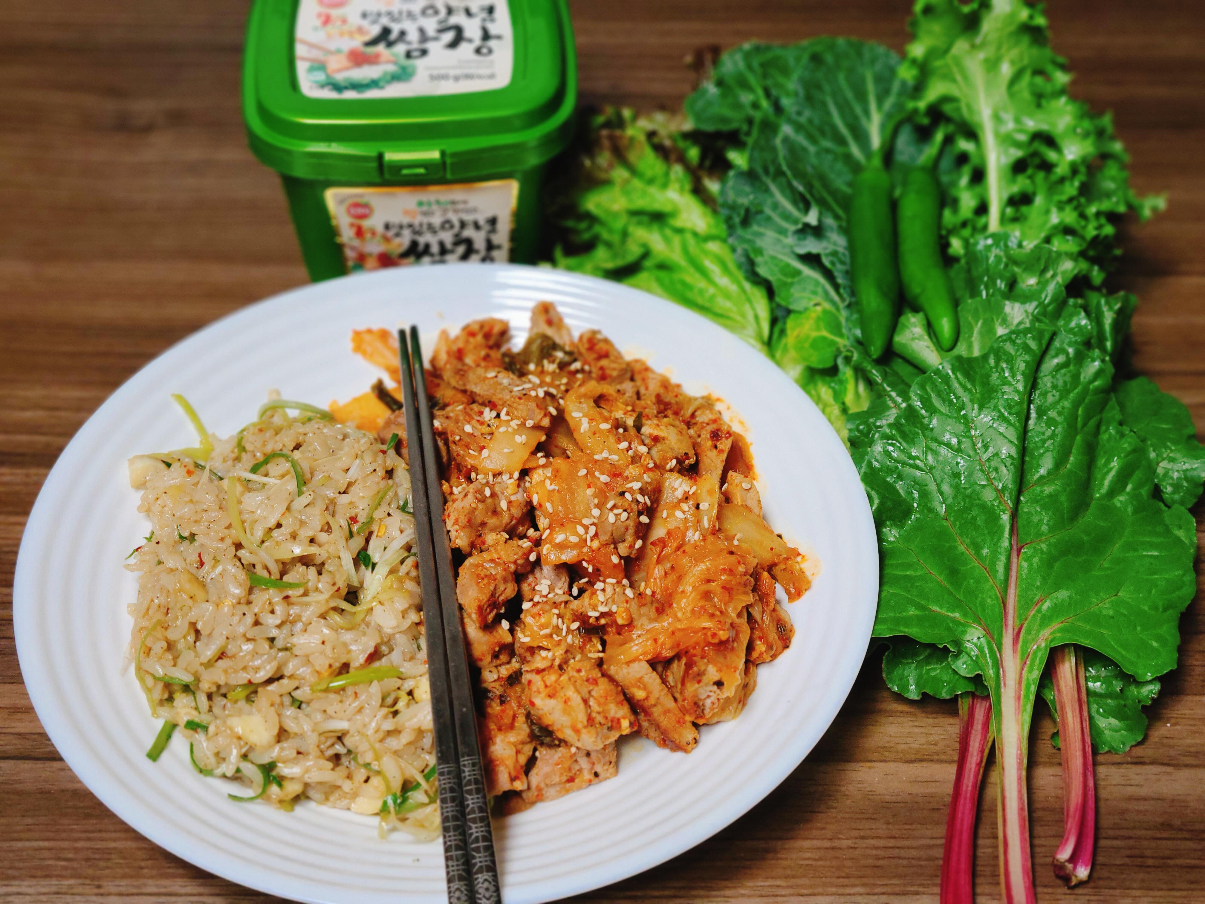 Korean stir fried pork and kimchi with rice and various lettuce wraps
