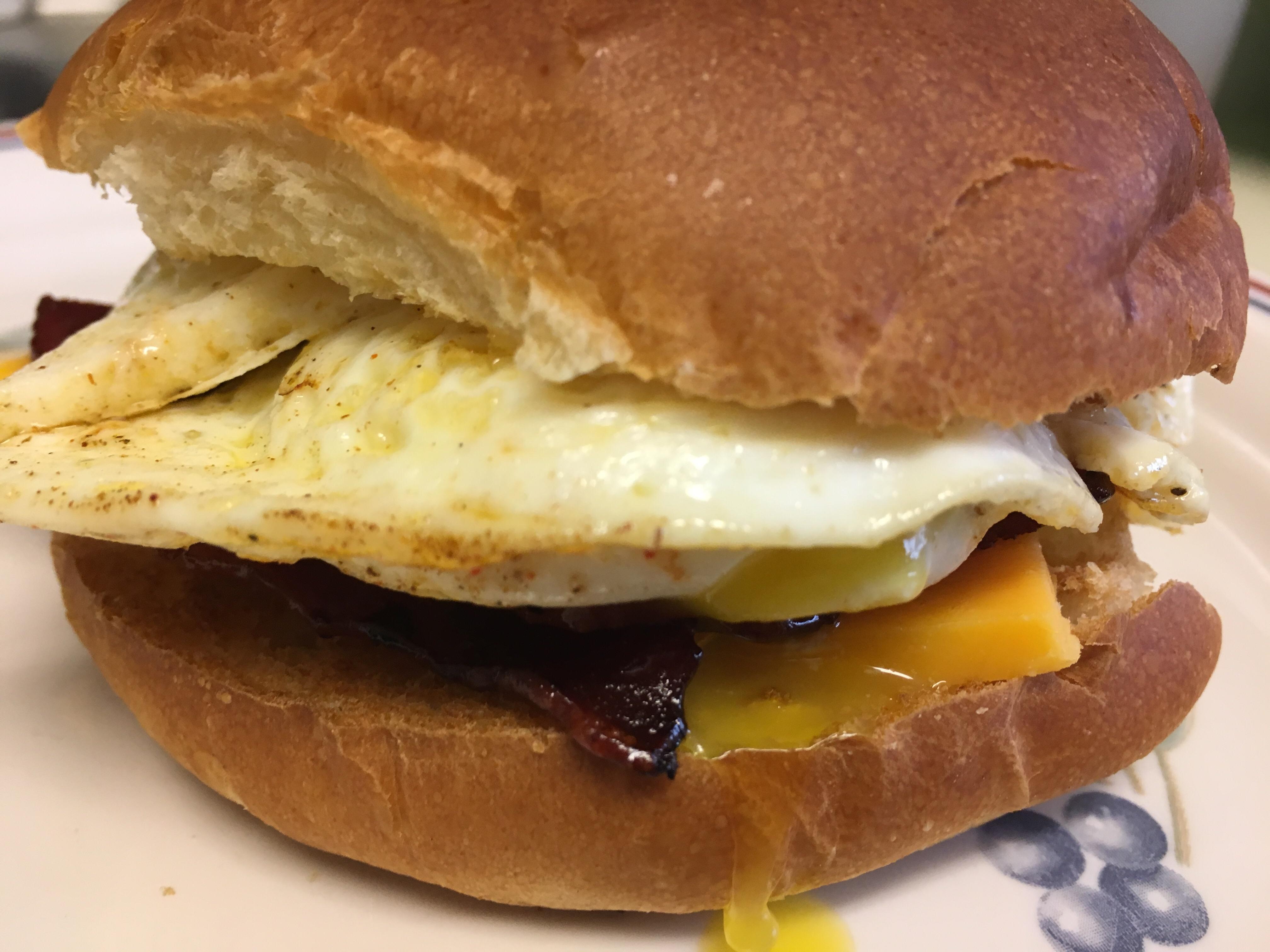 Turkey bacon, cheddar cheese, and delicious OM egg on a toasted bun r