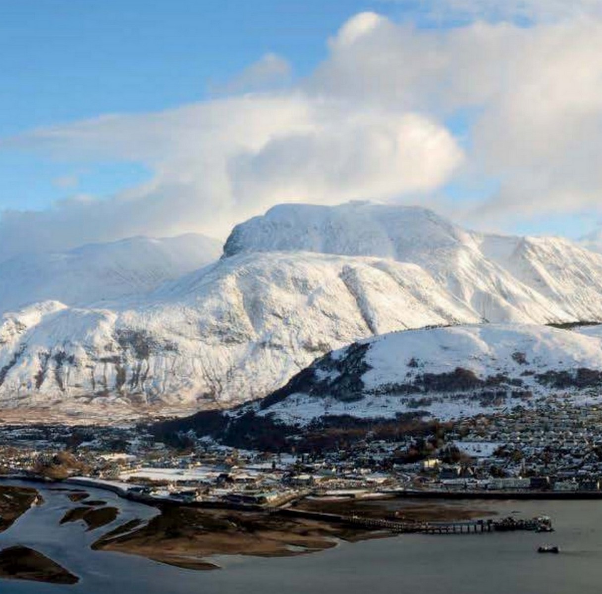 A wintry view of Fort William and Ben Nevis. r/Scotland