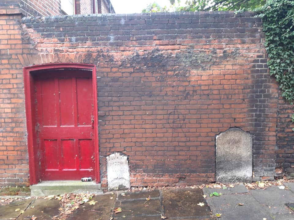 18th Century gravestones in situ with a Victorian garden wall cut