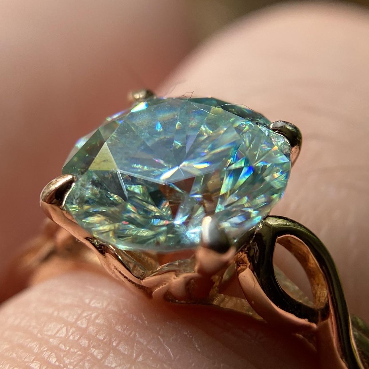 Super close up pic of my blue moissanite under indoor natural light r