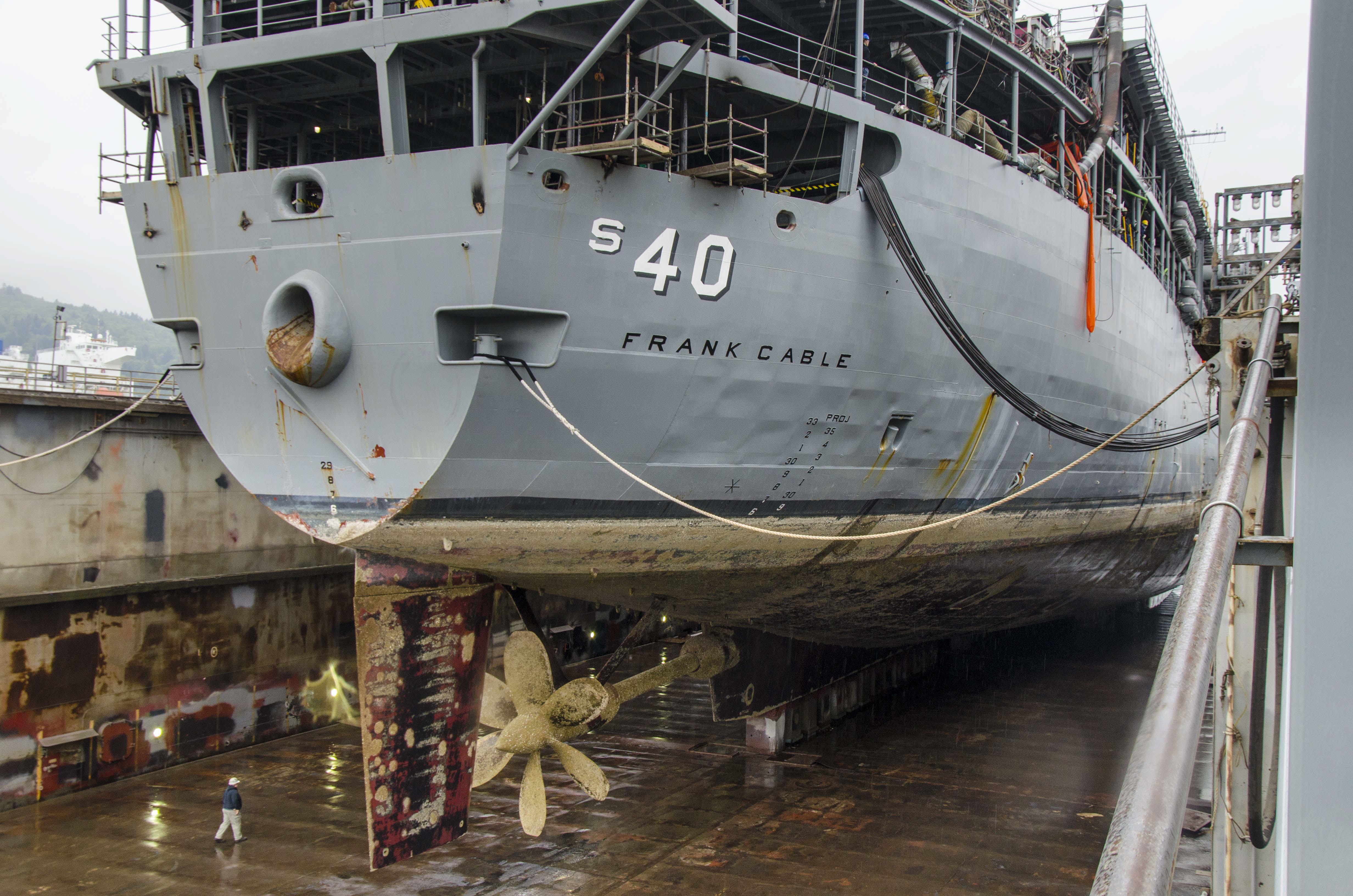 The submarine tender USS Frank Cable (AS40) rests as its drydock