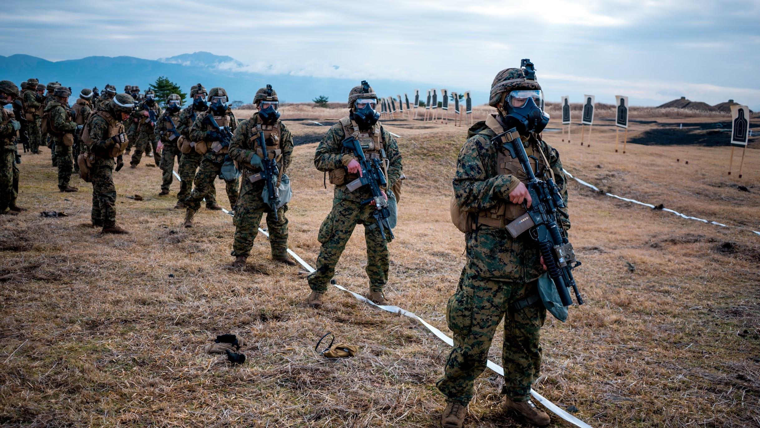 US Marines shooting with gas masks at the base of Mt Fuji [2436x1373