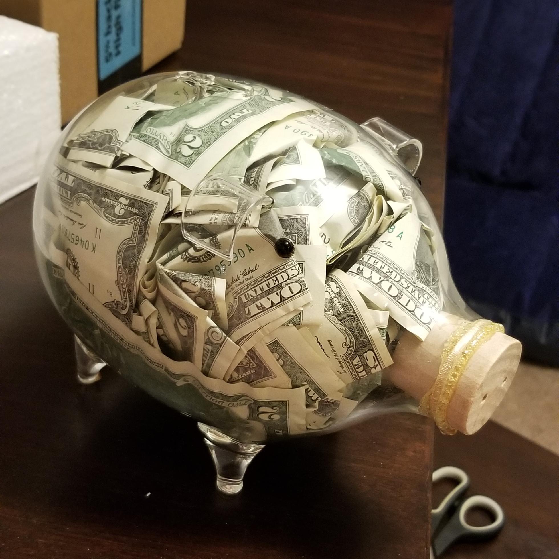Piggy bank full of two dollar bills I'm giving a friend as a wedding