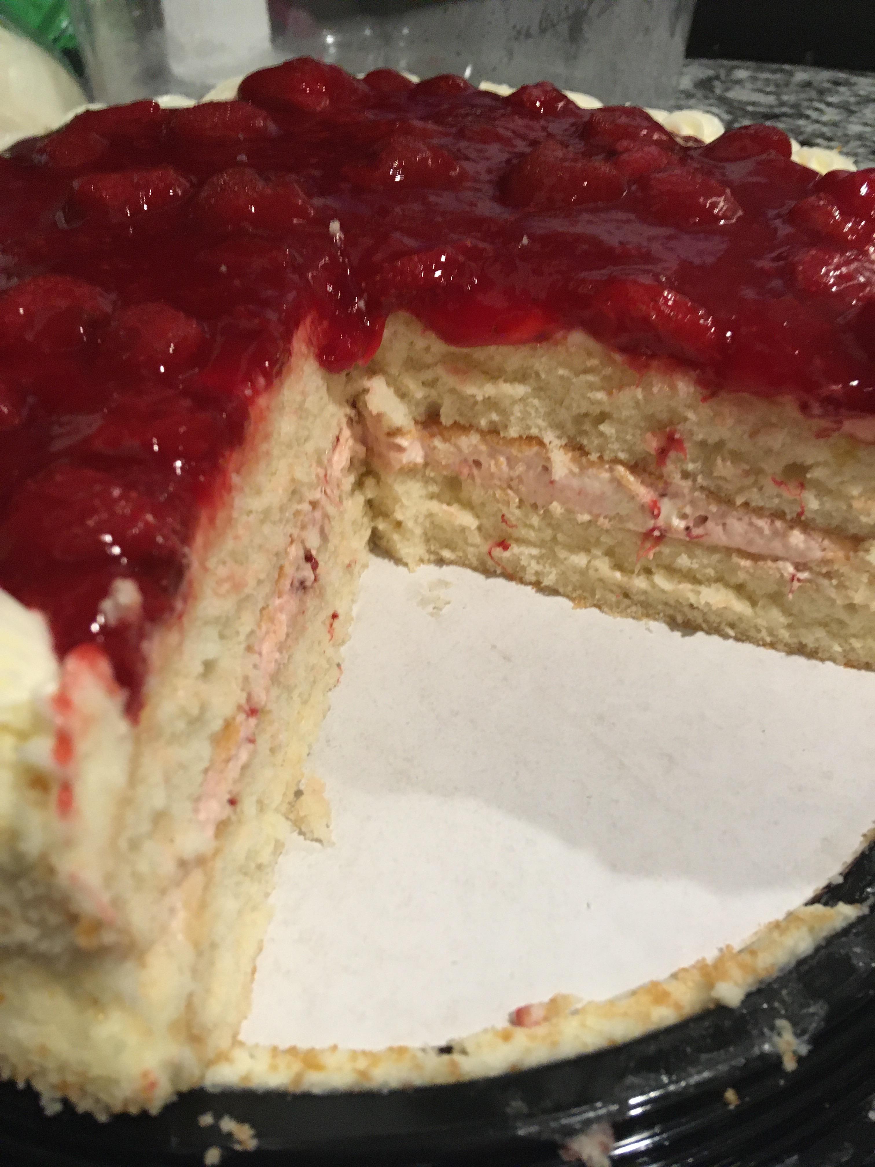 New cake is amazing. White cake filled with strawberry mousse topped