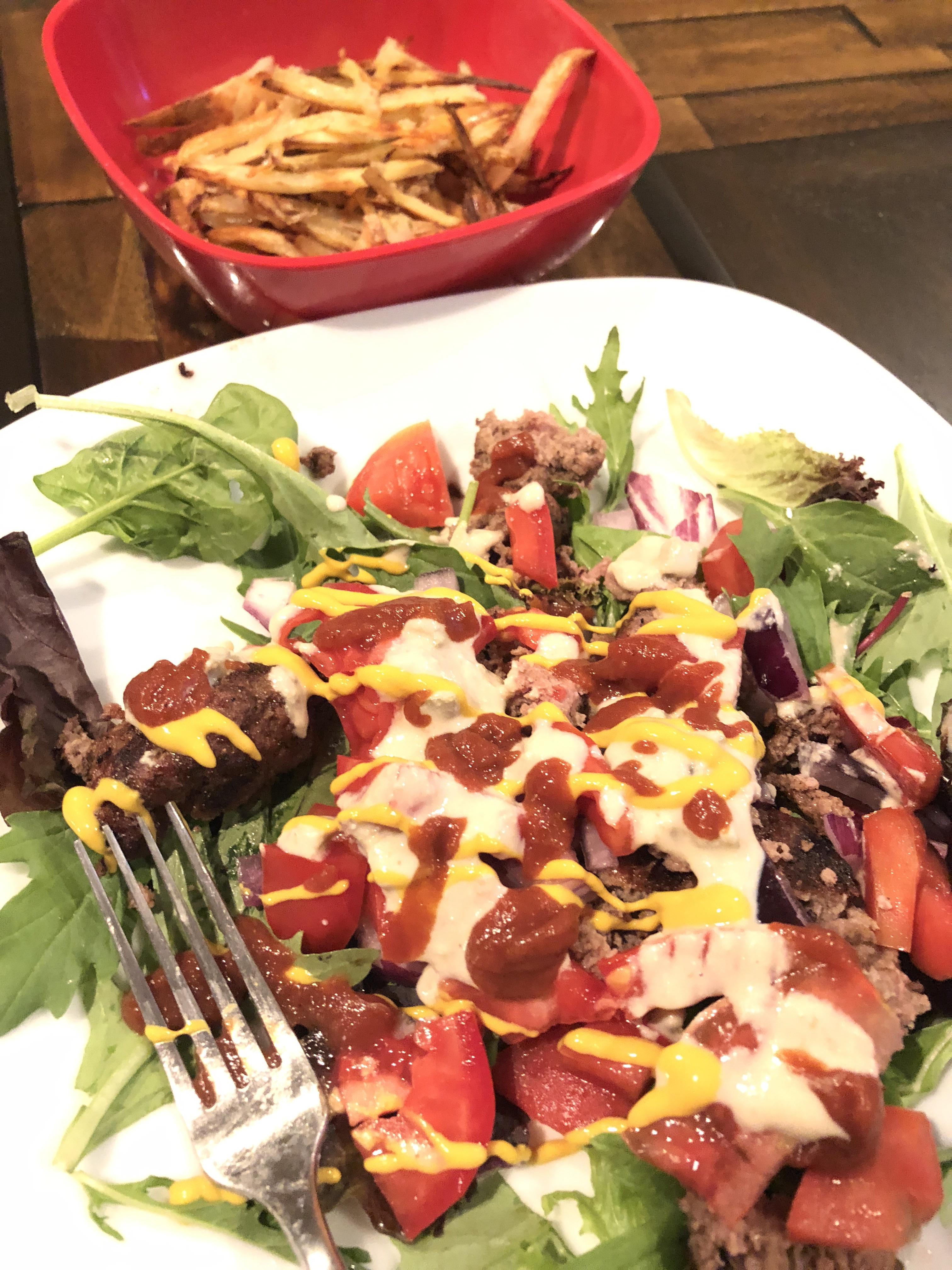 Burger salad with compliant ketchup and mustard and ranch! Complete