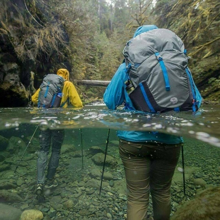 PsBattle Two people hiking through water