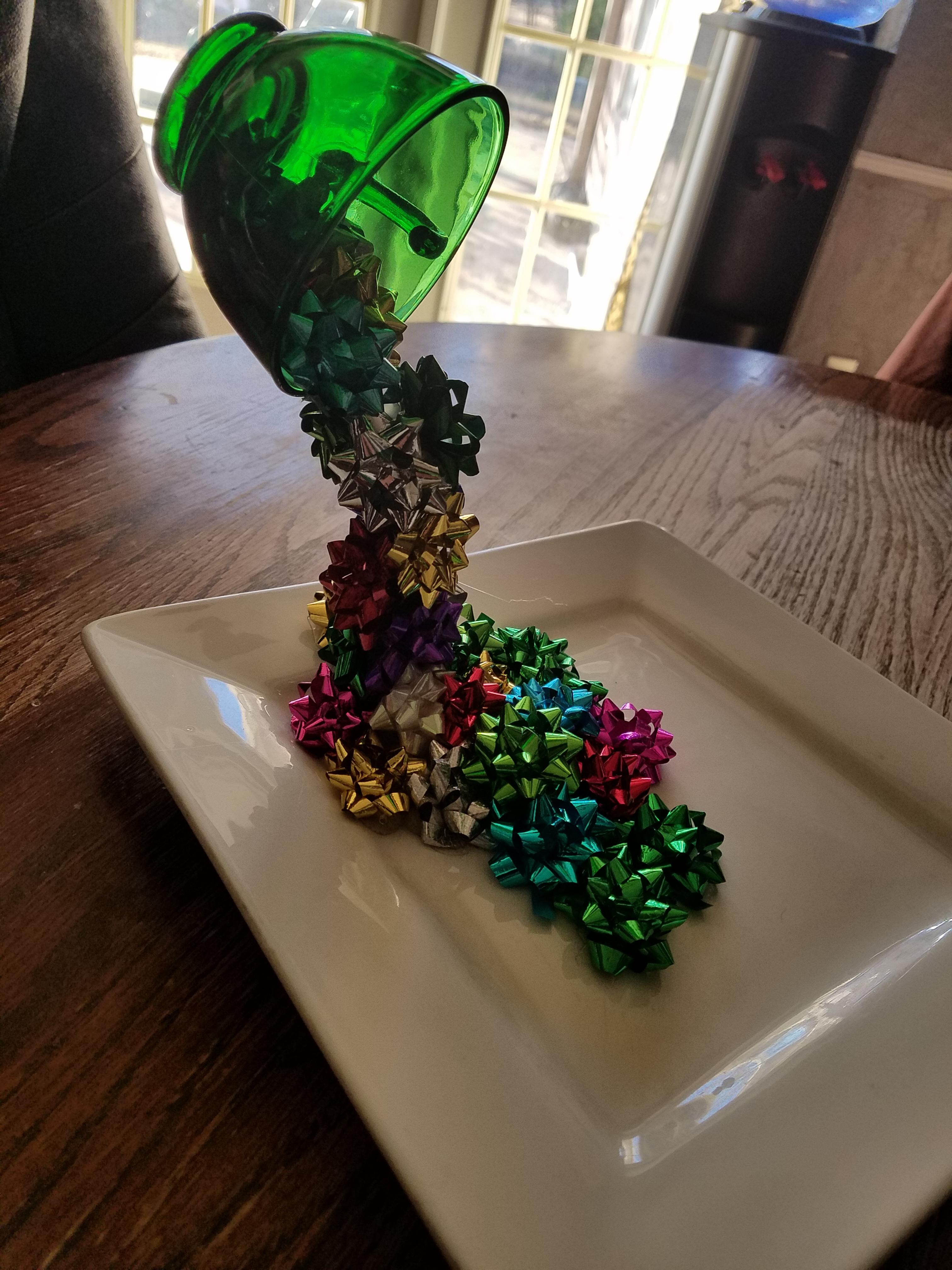 Using hot glue a glass tea cup, a bent fork, a plate and a ton of tiny bows, I made a cute