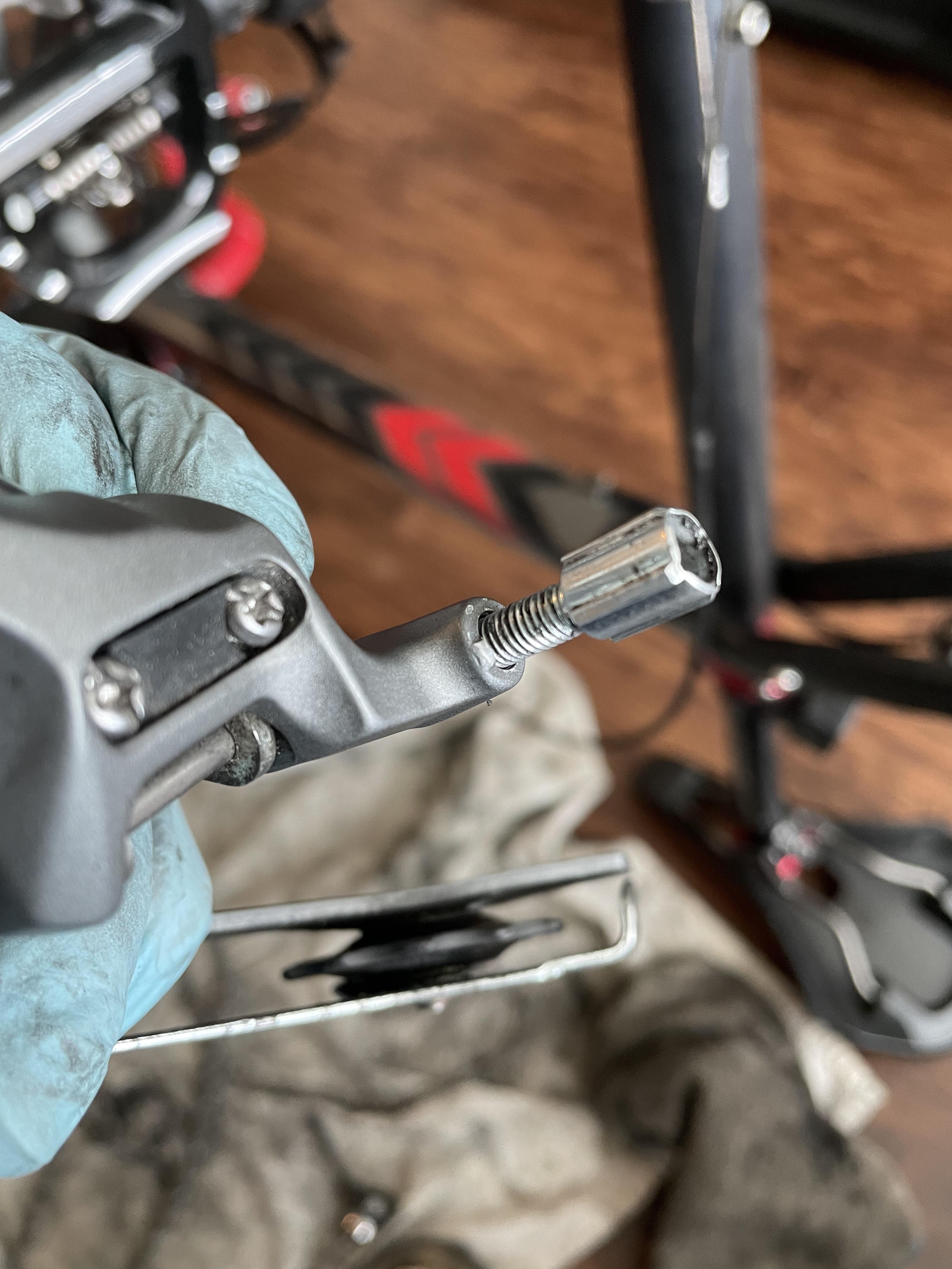 Barrel adjuster won’t thread into rear derailleur. Seems derailleur