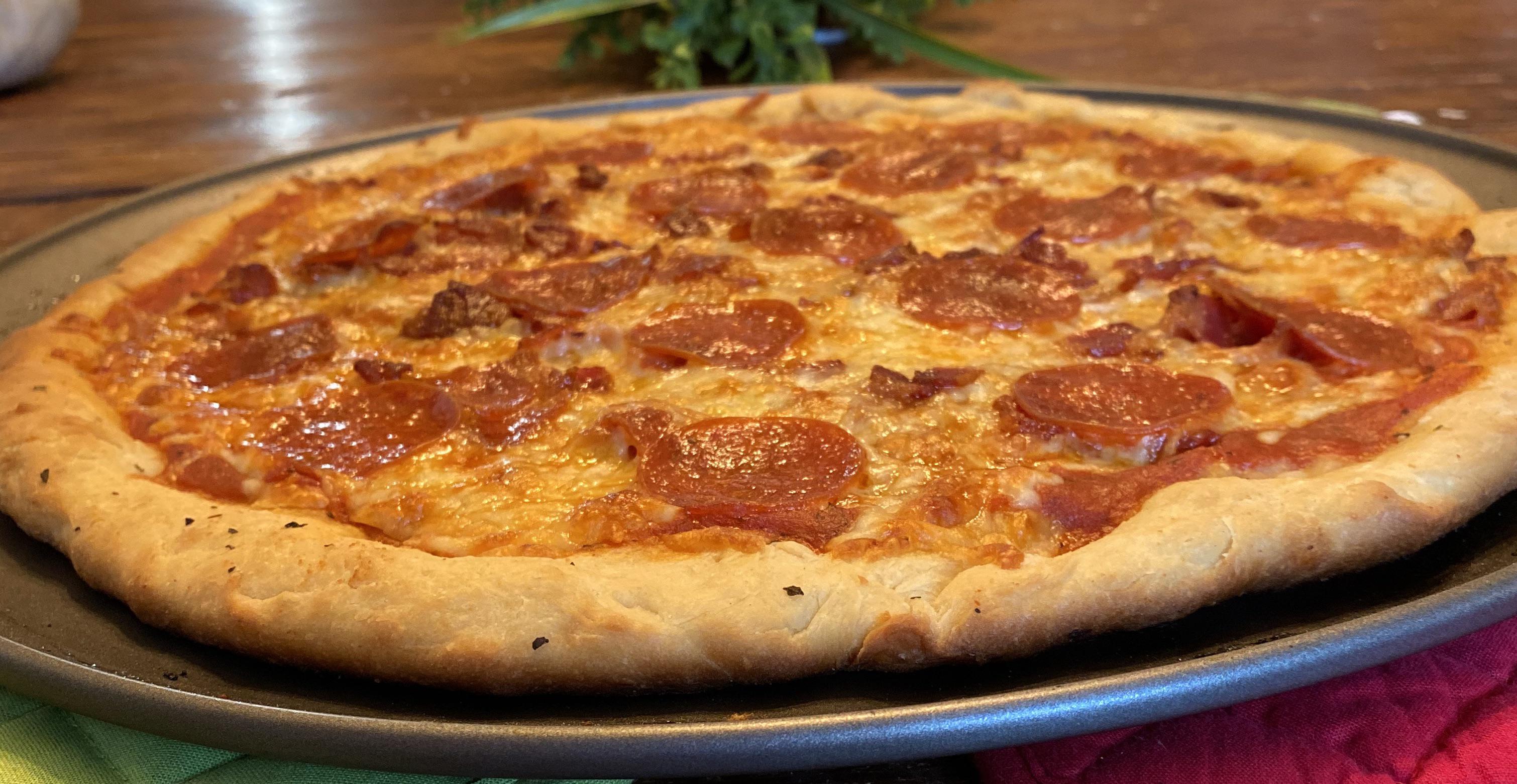 Homemade wood fired pizza! Started with a handmade garlic bread crust