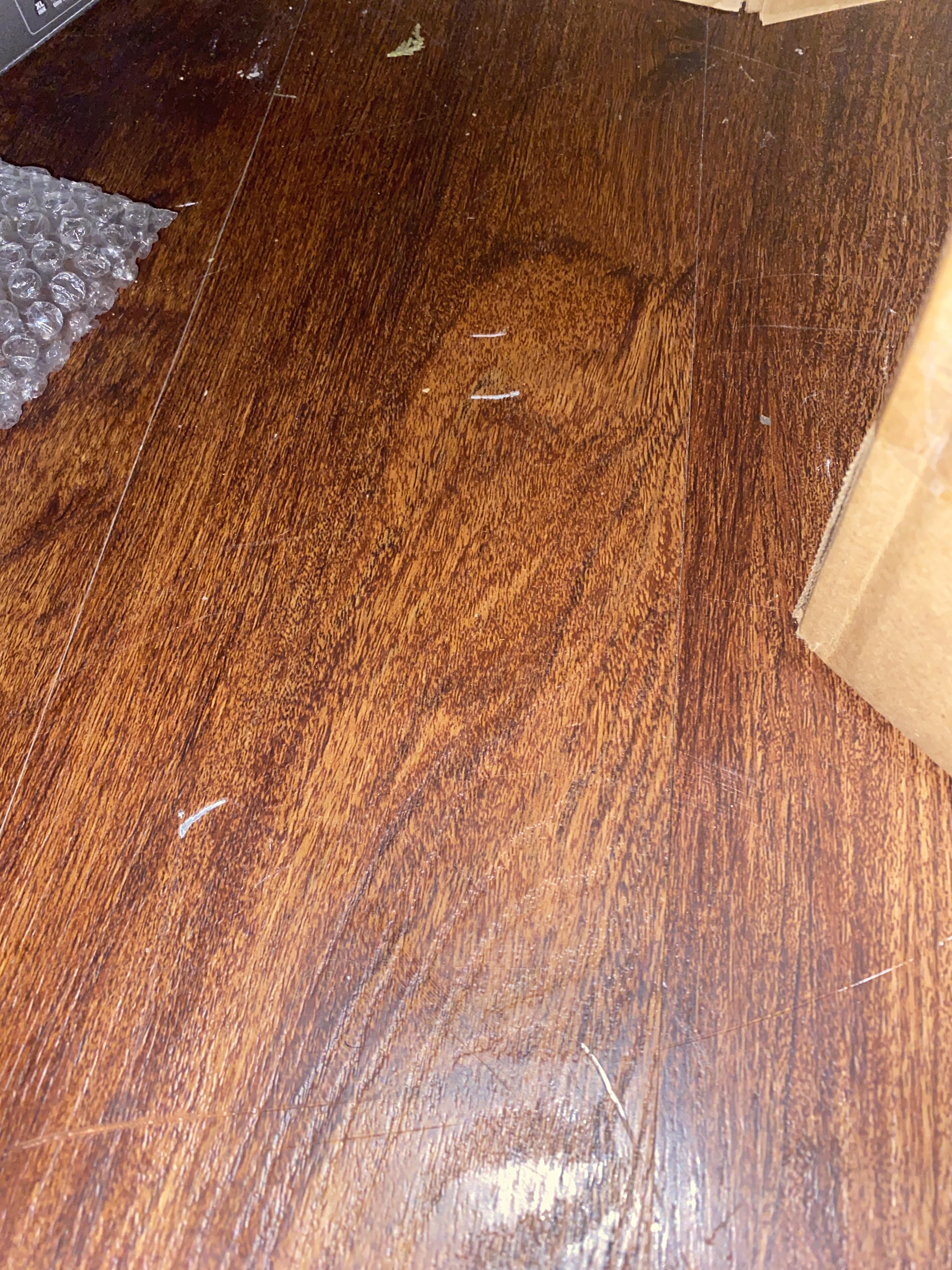 How can I get rid of (or hide) these scratches on my fake wood floor