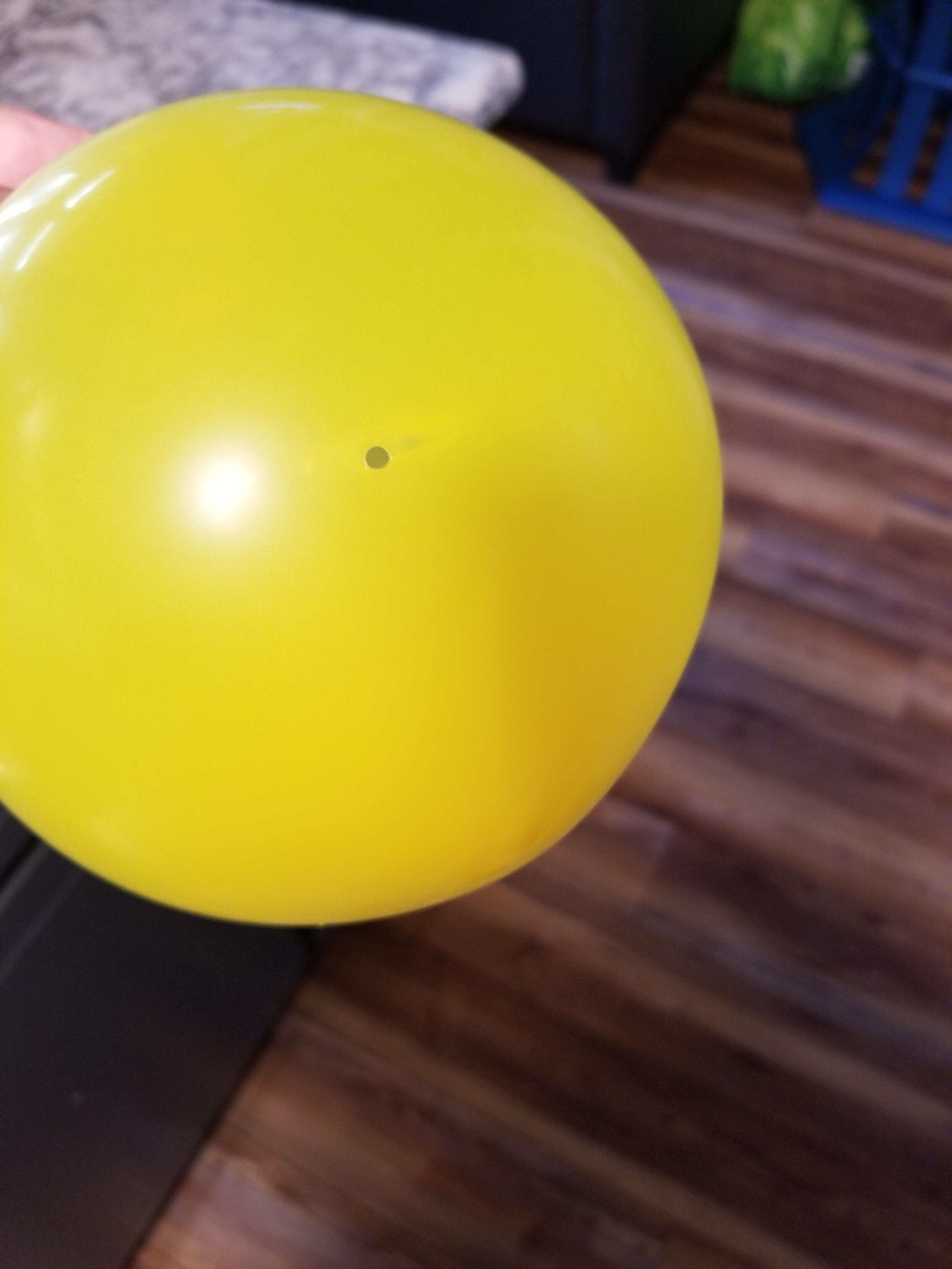 A birthday party balloon with a perfect hole that lets air out but didn