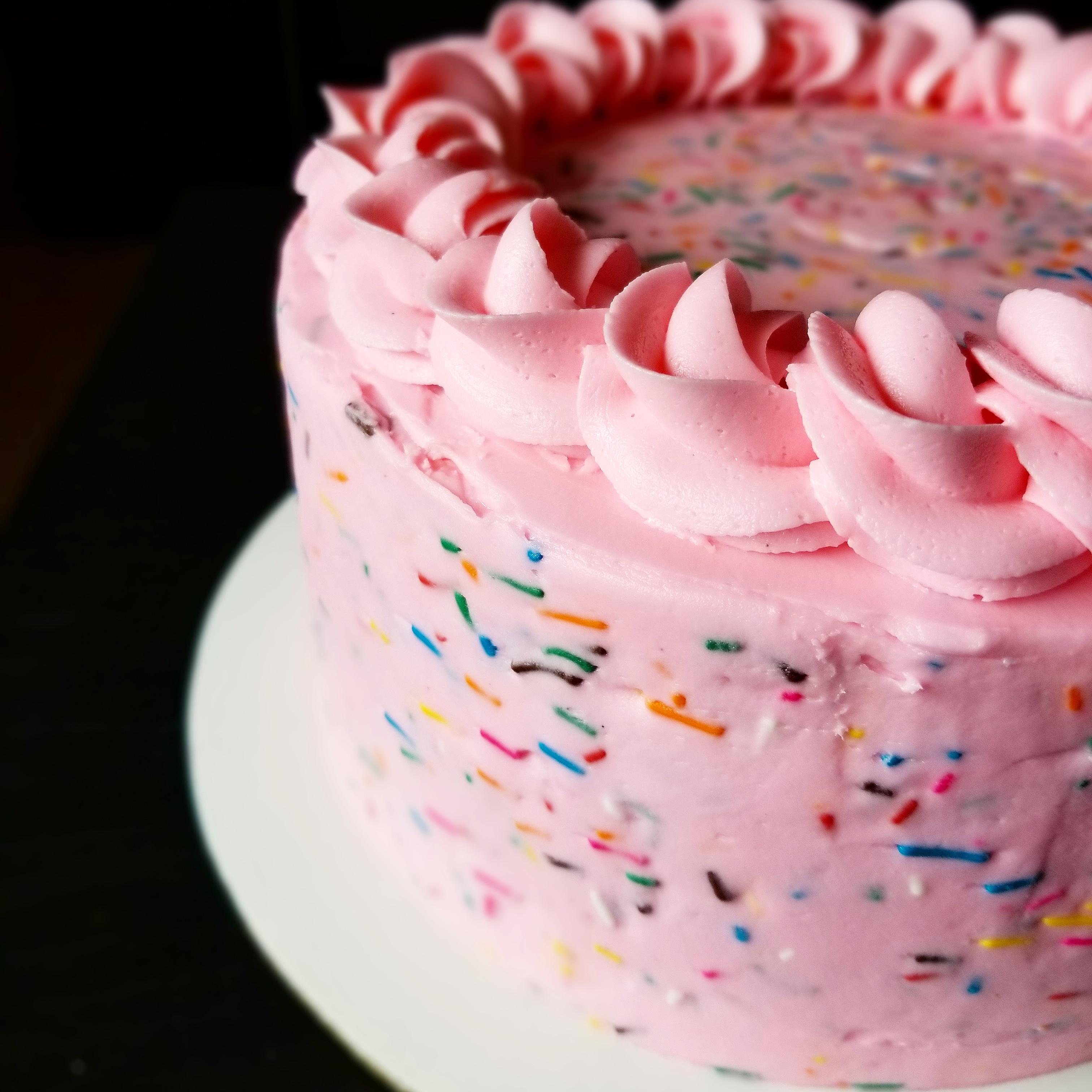 First time putting sprinkles in the frosting! Vanilla cake, strawberry