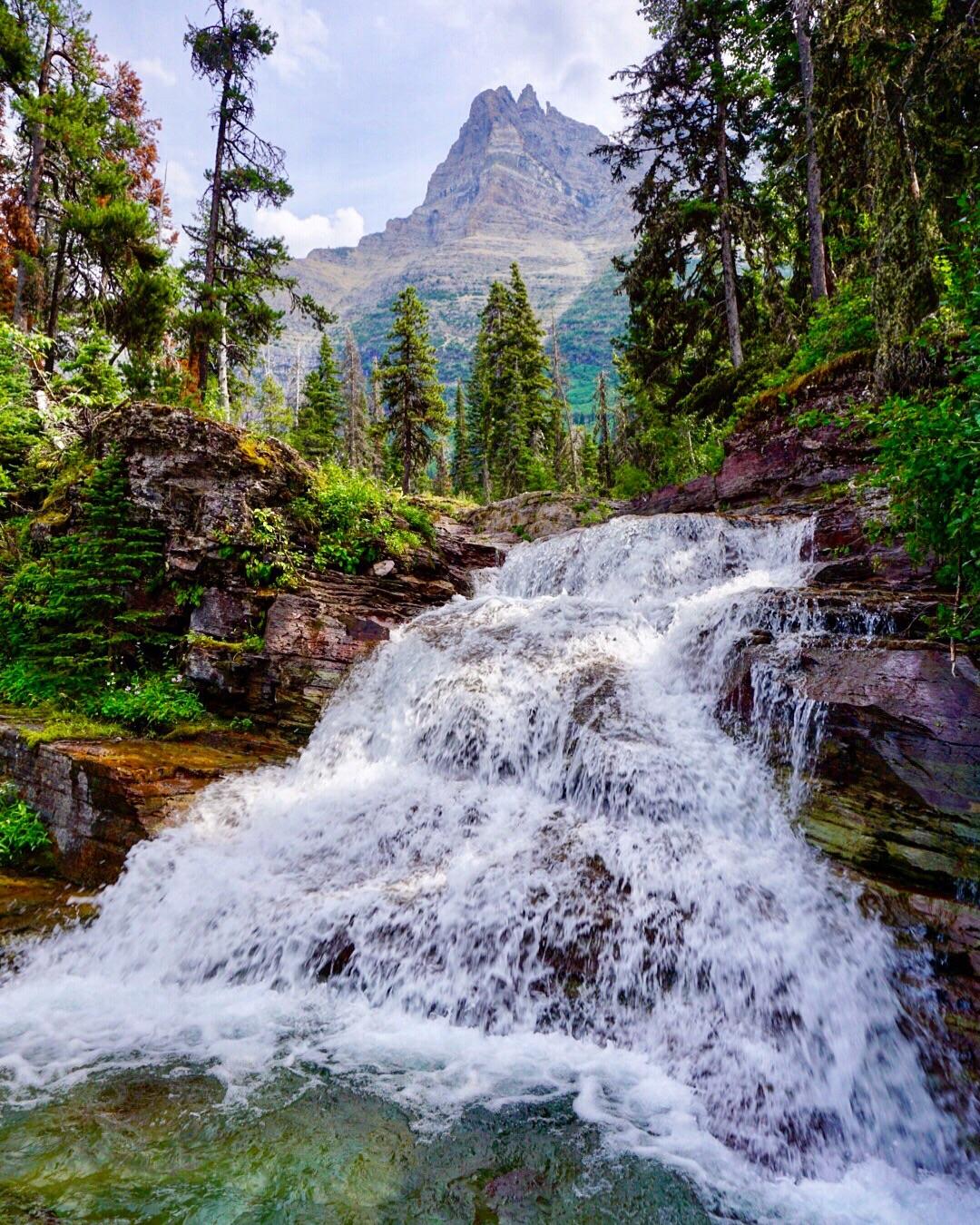 One of the many stunning waterfalls in Glacier National Park, MT [OC