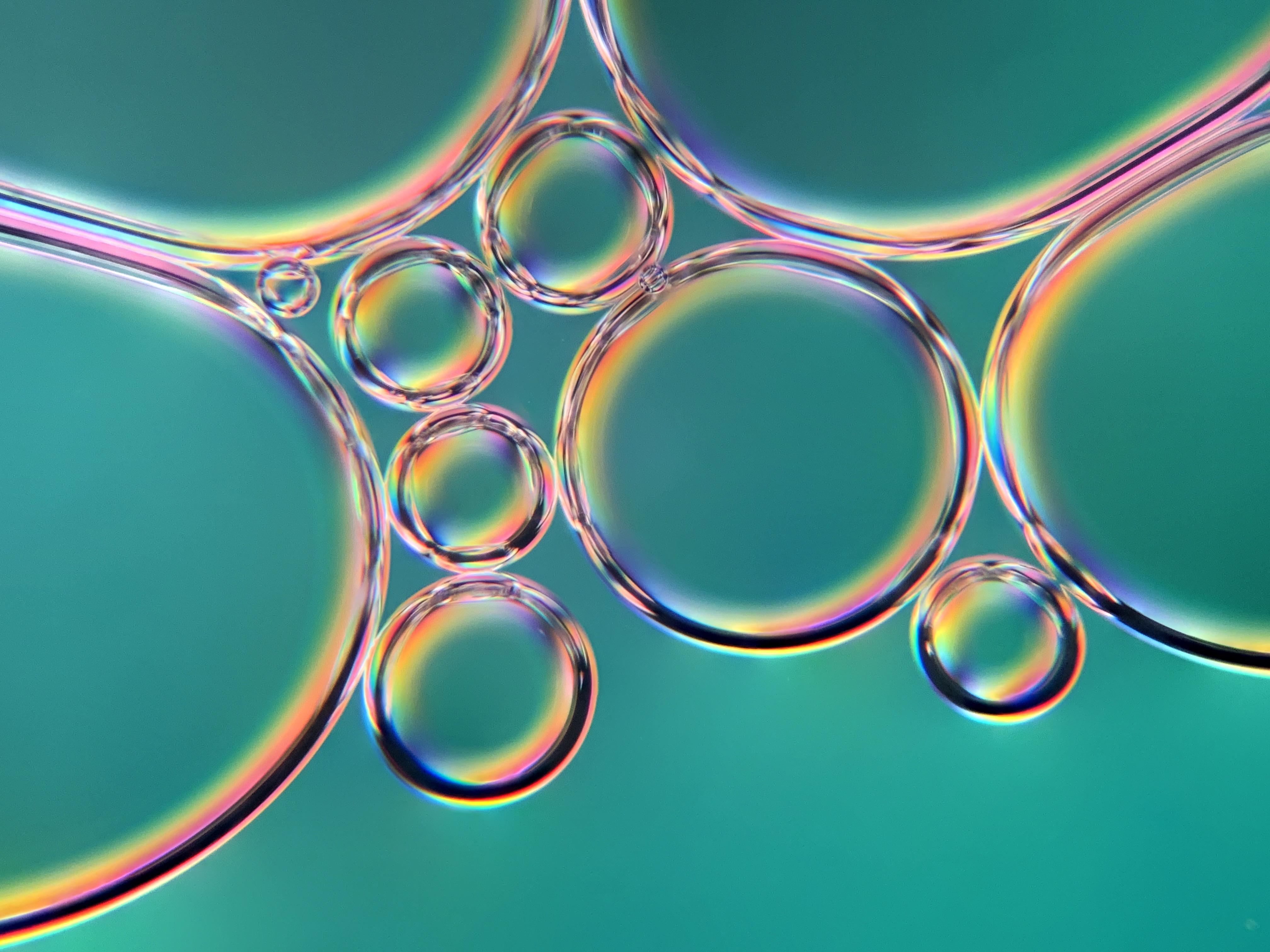 Tiny bubbles under a microscope at 100x magnification in polarized