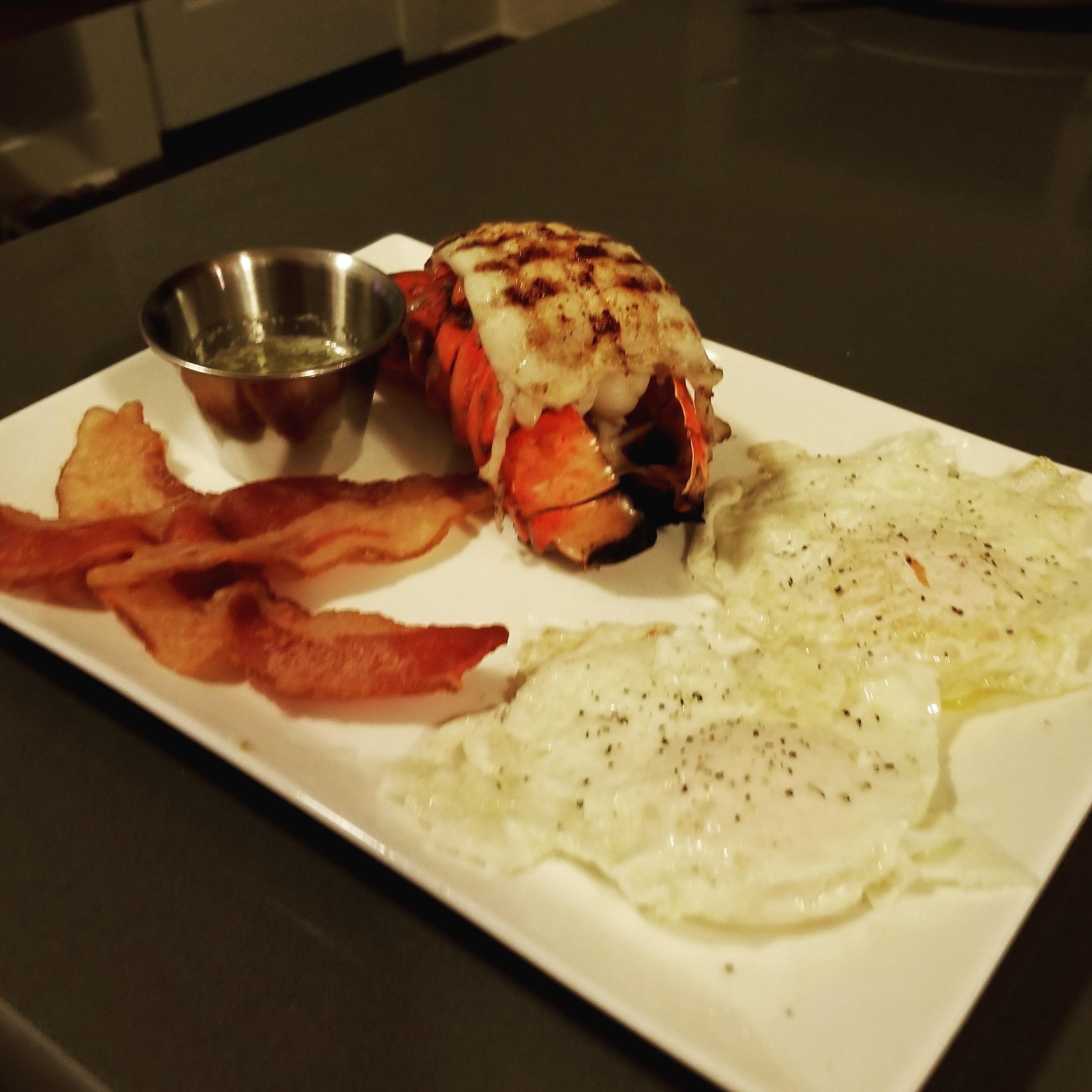 Post workout grilled lobster tail with garlic butter, eggs and bacon