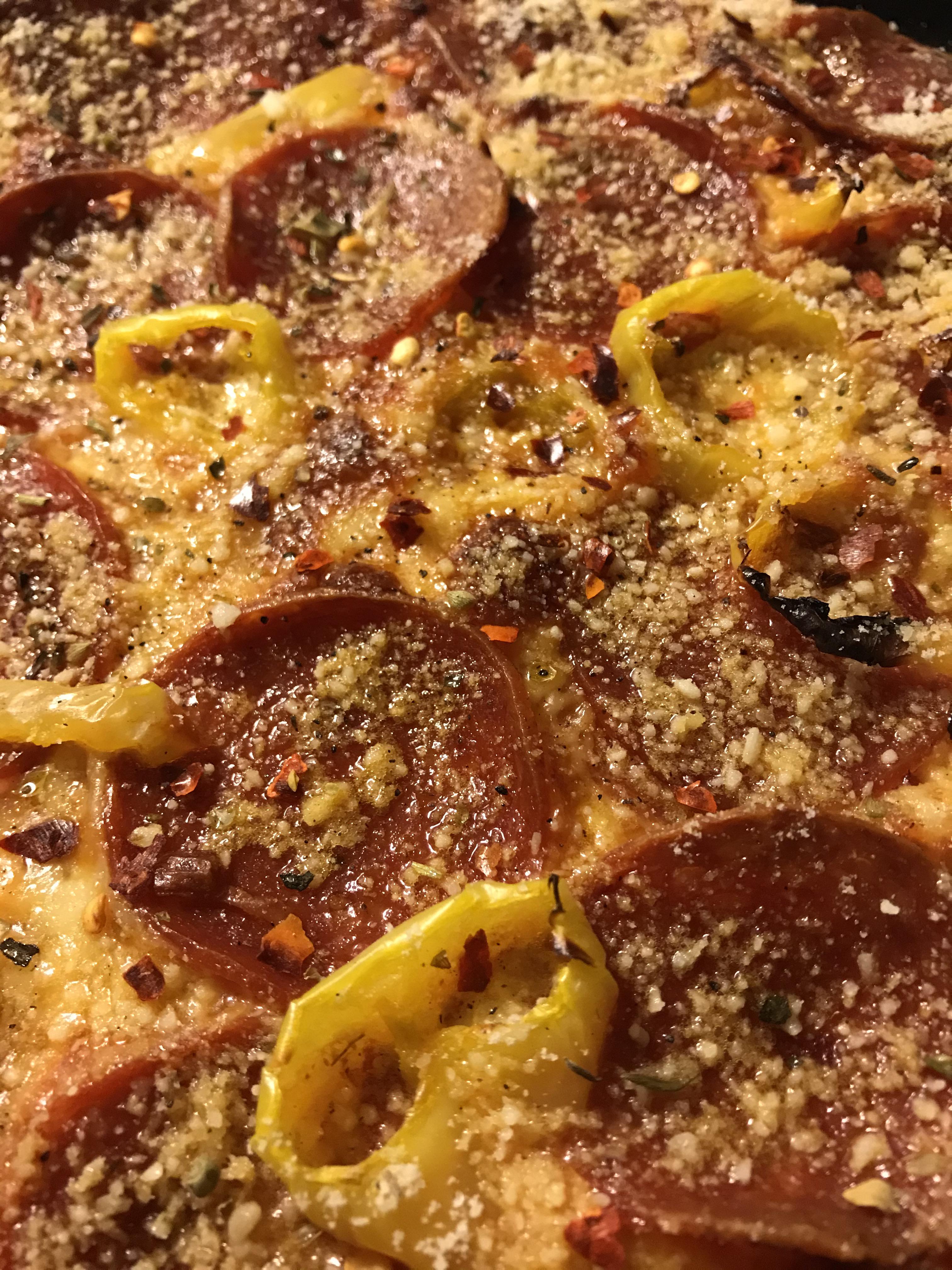 Pepperoni and banana peppers topped with grated parmesan, Italian herbs