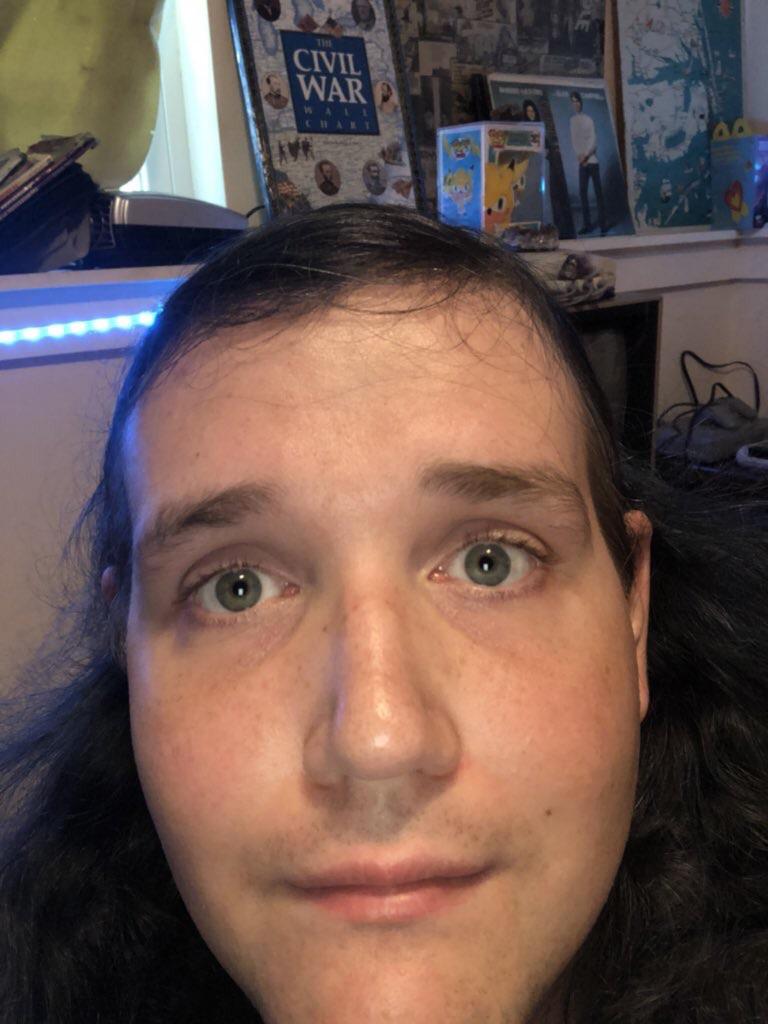 Why does he draw himself with two different eye colors