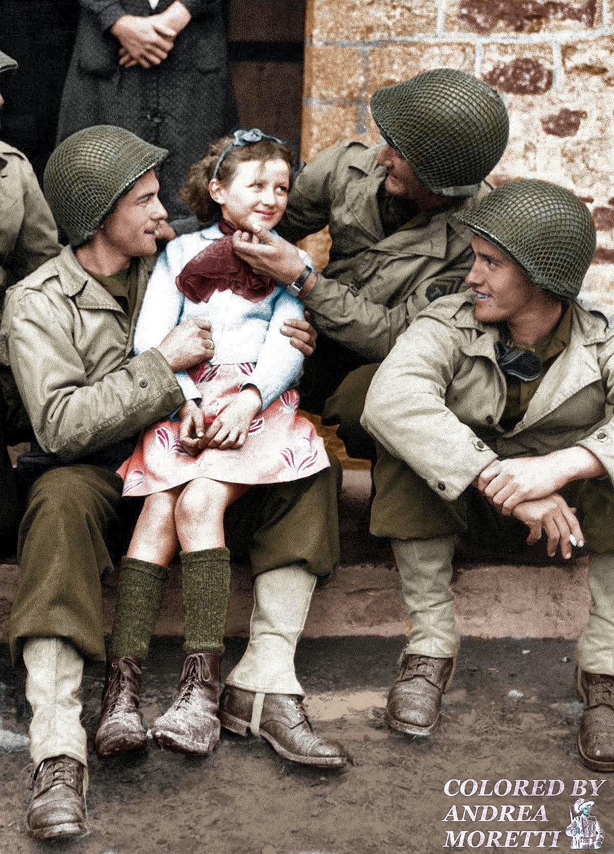 [Colorized] French little girl with three American admirers. Normandy
