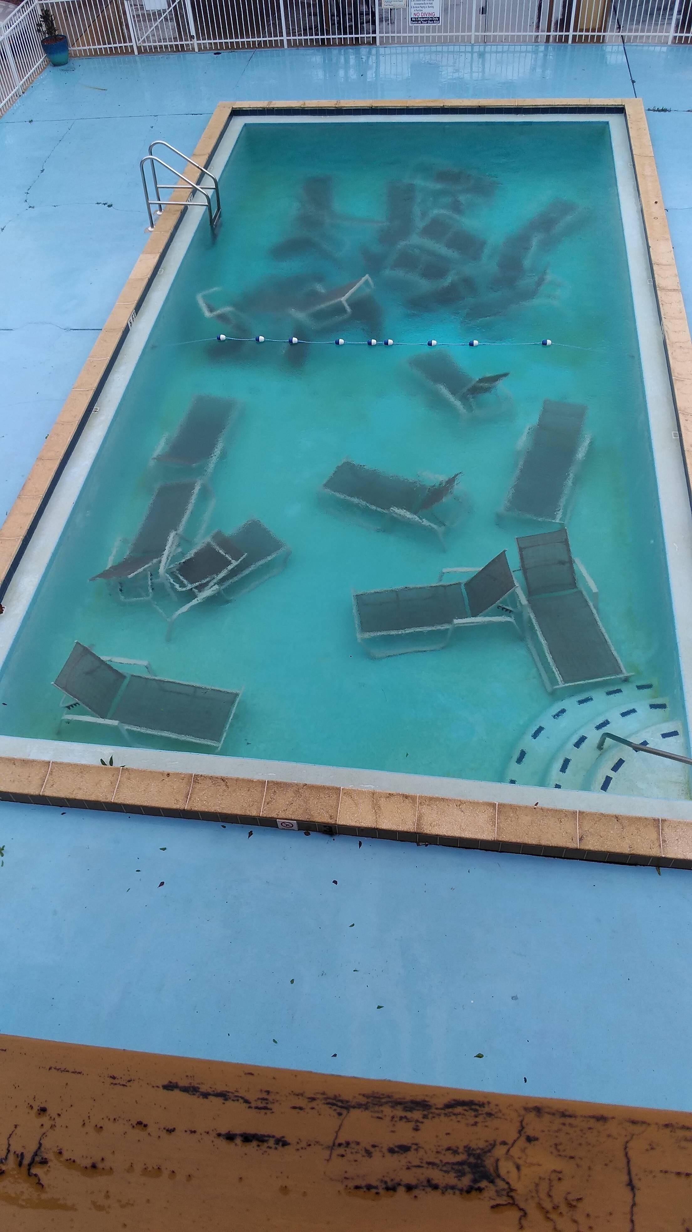 Chairs chilling in a pool r/chairsunderwater