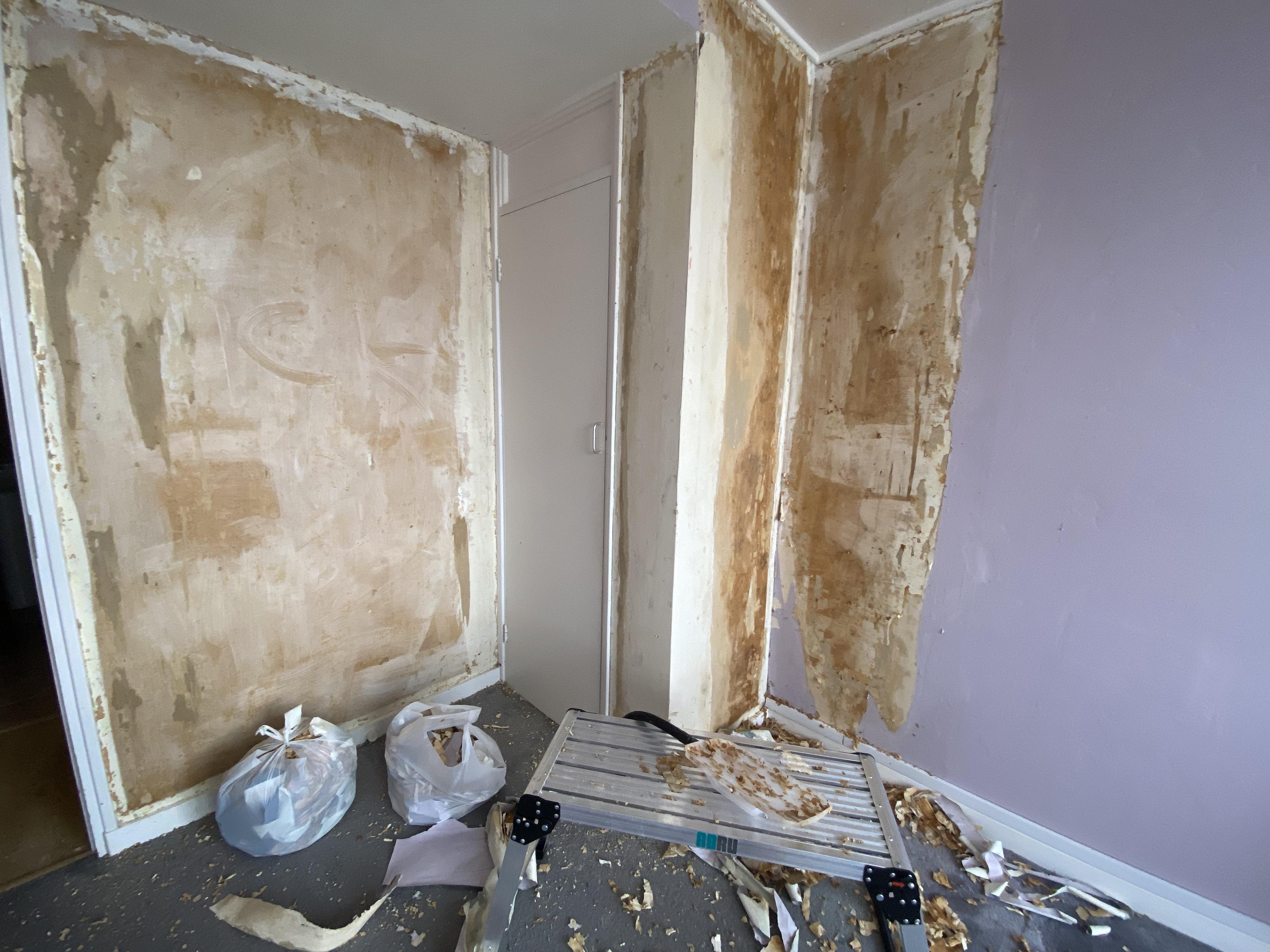 Stripping wallpaper there’s three layers of it and paint on top. This