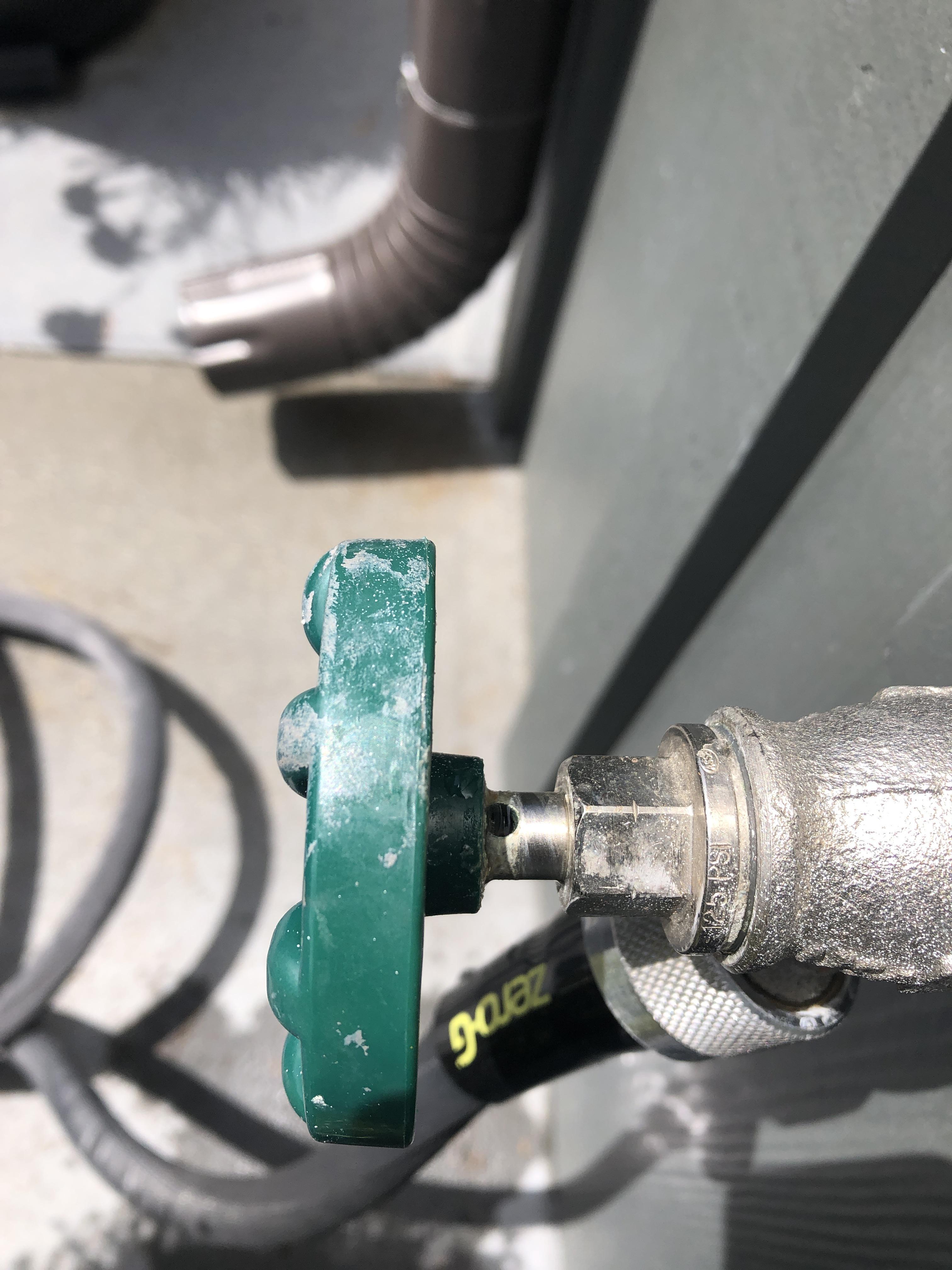 Water spurts from the hole on this faucet when the sprayer on hose is