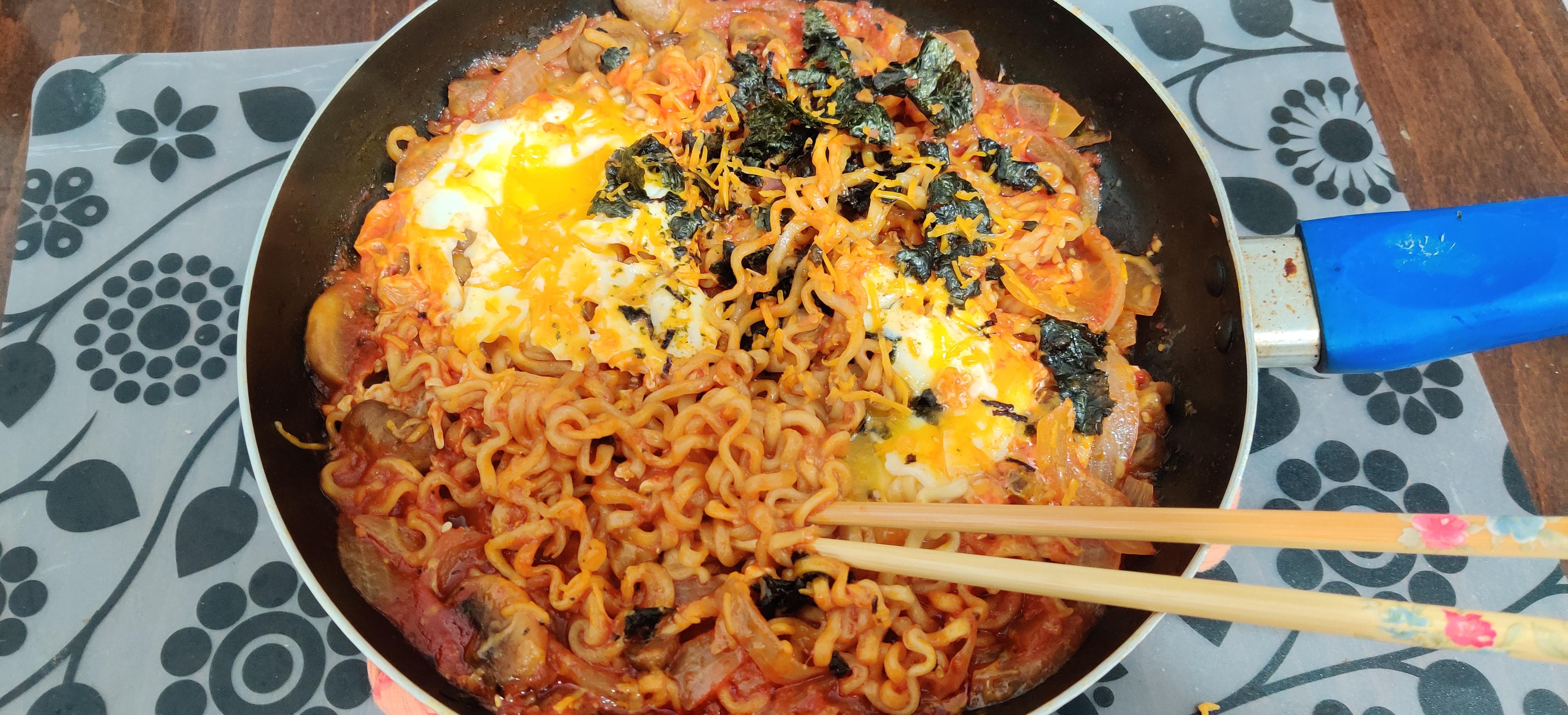 Buldak eggs in hell with grated smoked cheese! Used Samyang 2x for this