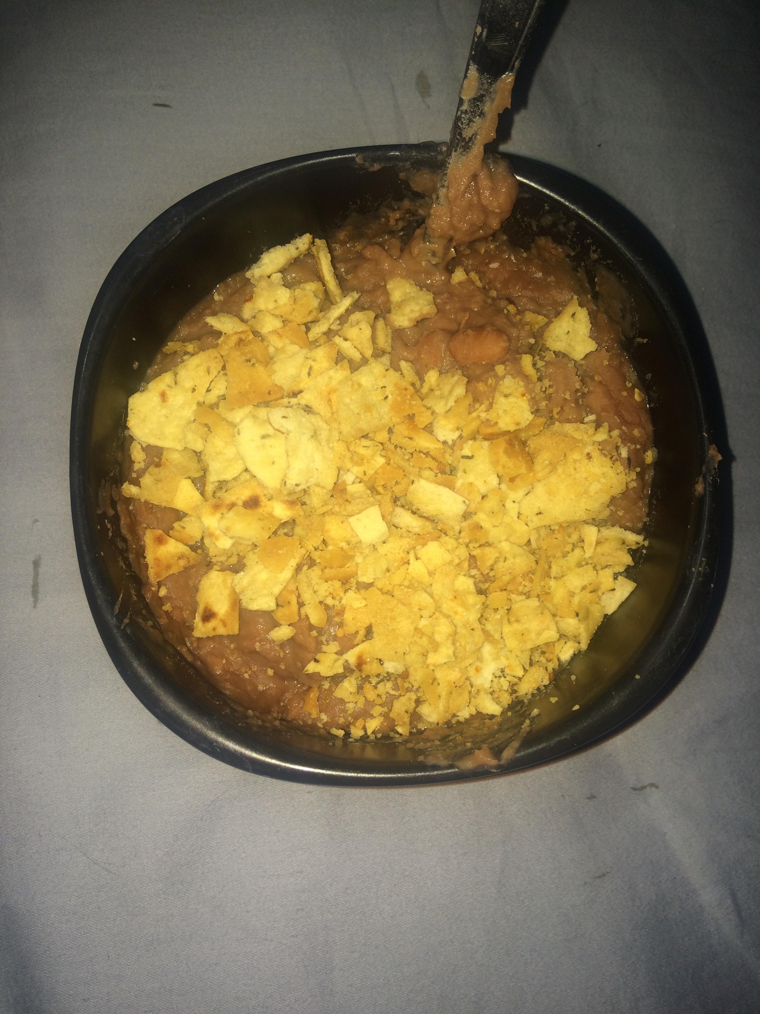 An entire can of refried beans that I found buried in my cabit, with
