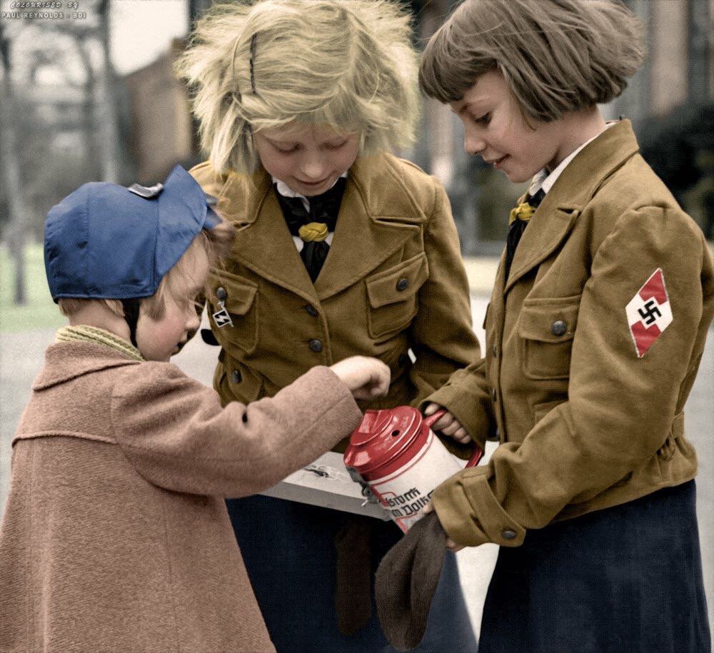 Colorized photo of two young German girls collecting donations for the war effort. Date Unkown