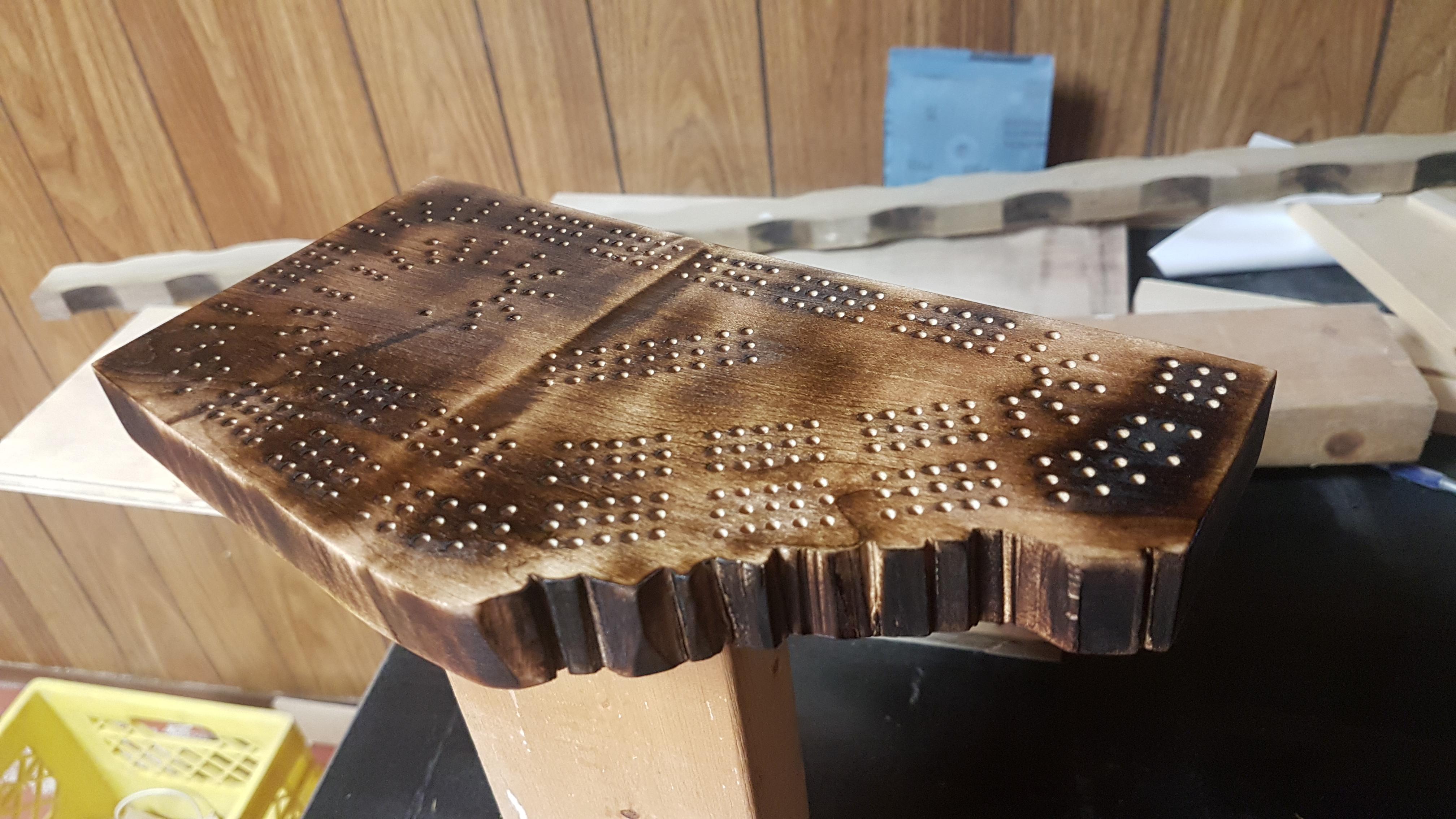 An Alberta cribbage board I made. Burnt maple and self designed pattern