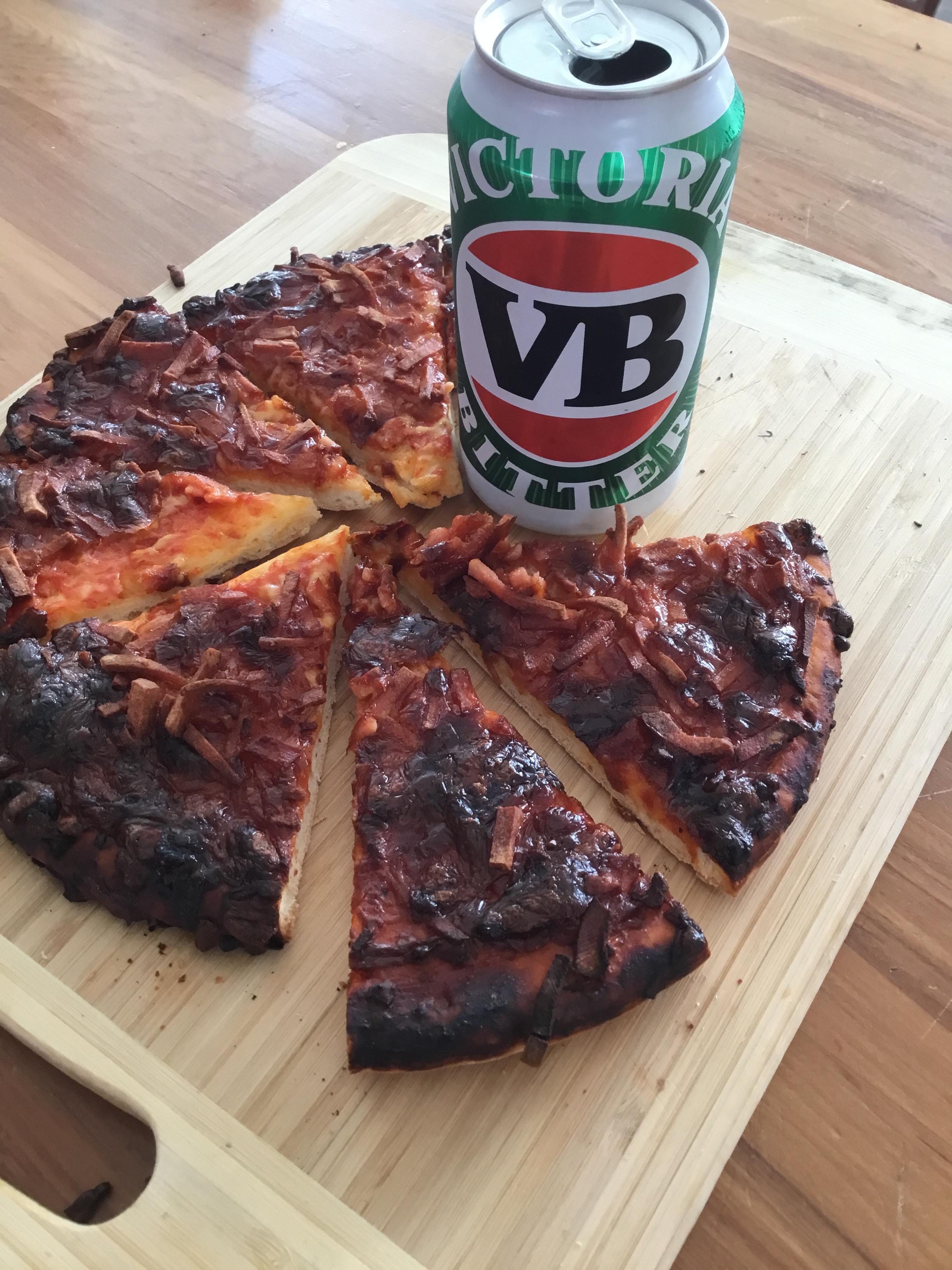 Burnt pizza and a VB just how I like it. r/beerandpizza