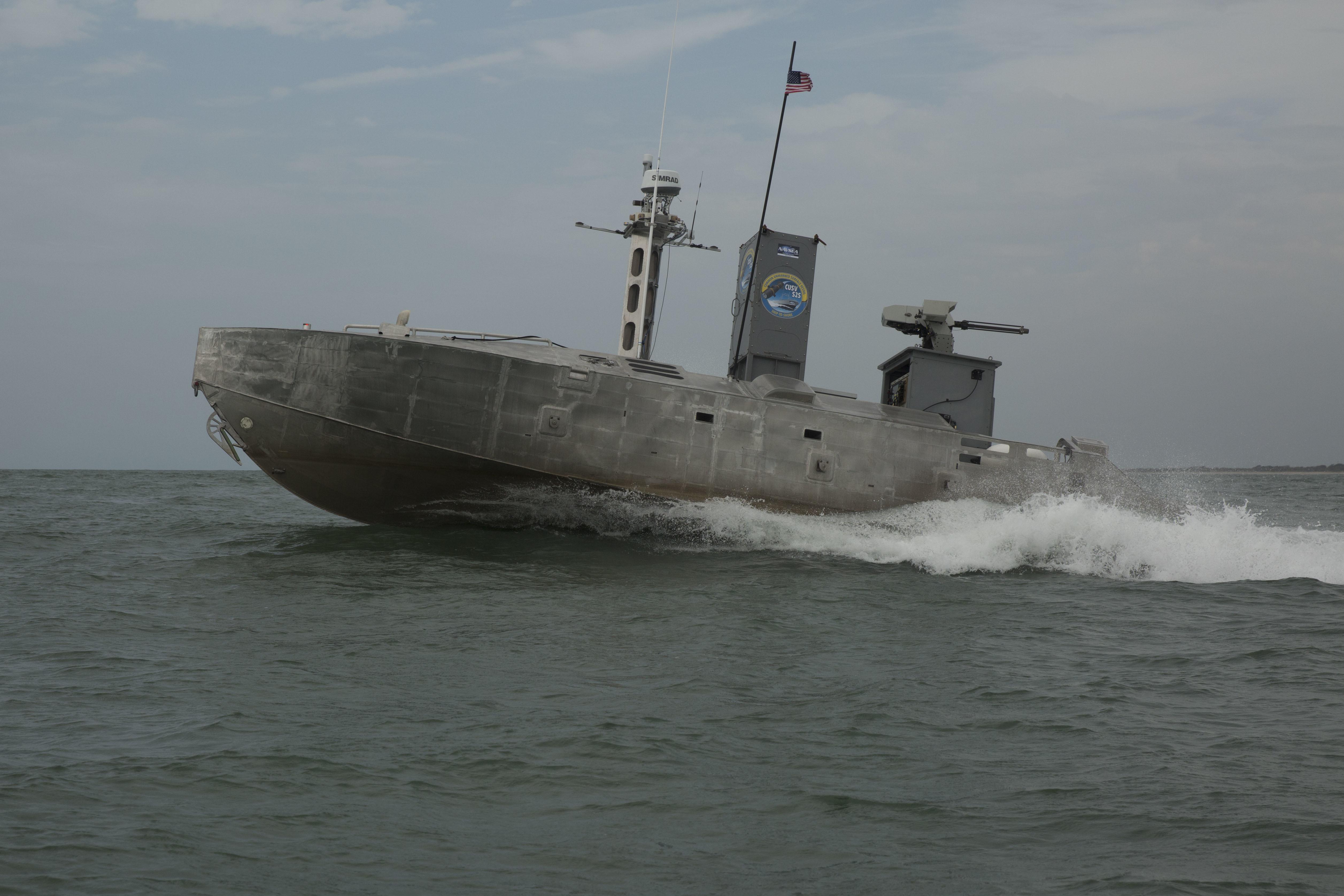 An expeditionary warfare unmanned surface vessel (USV) autonomously