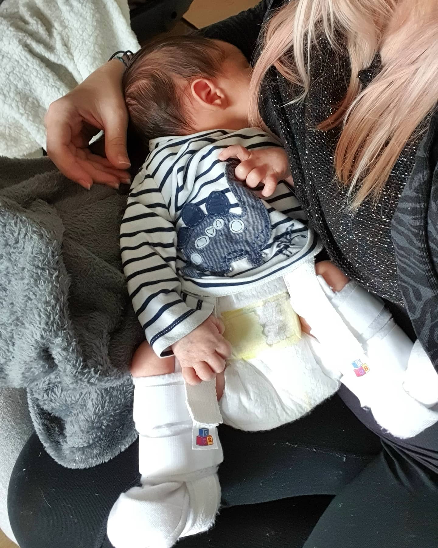 Hi all, any advice on breastfeeding with a harness? Painful latch, more