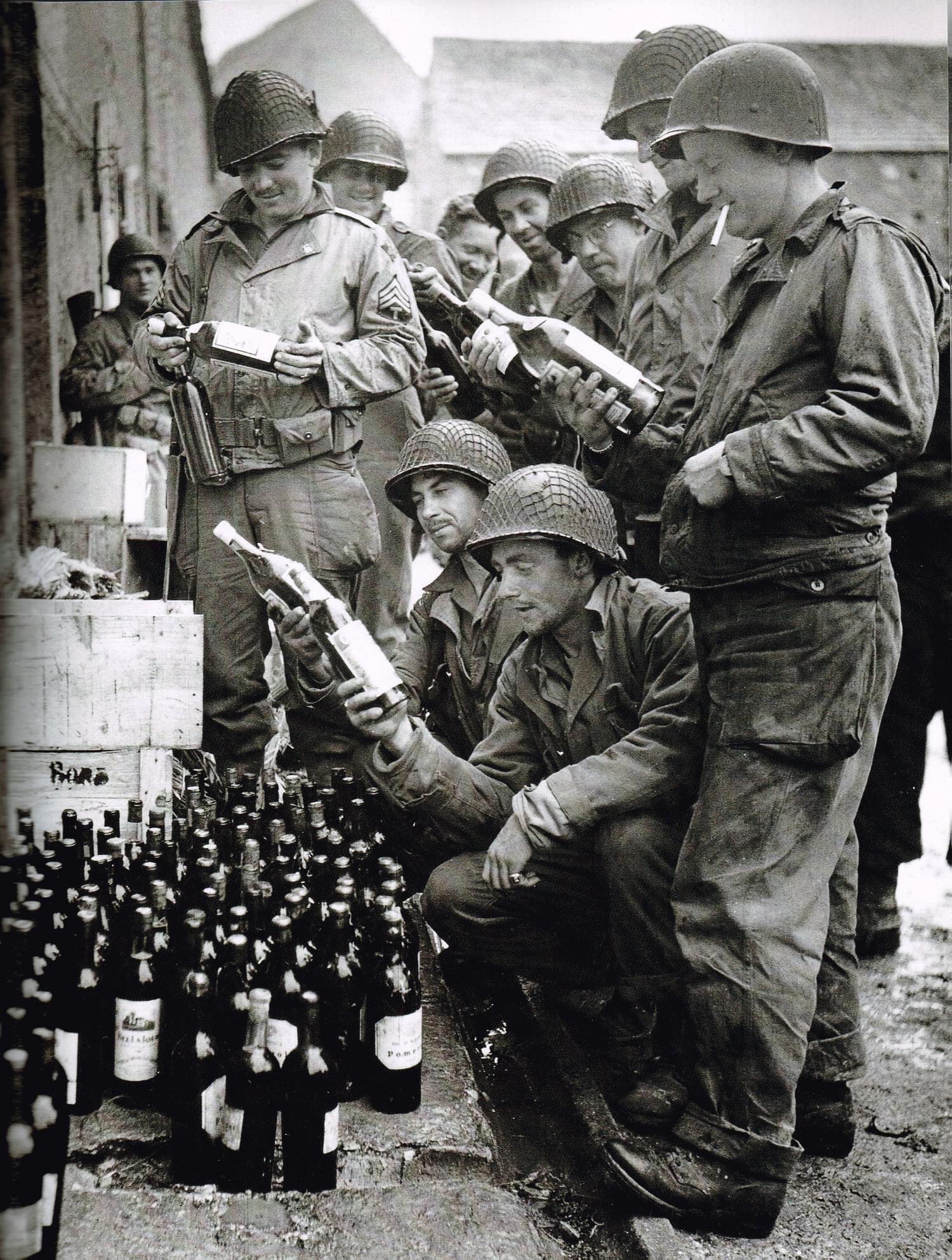 GIs of the 4th Infantry Division examining some “liberated” wine in