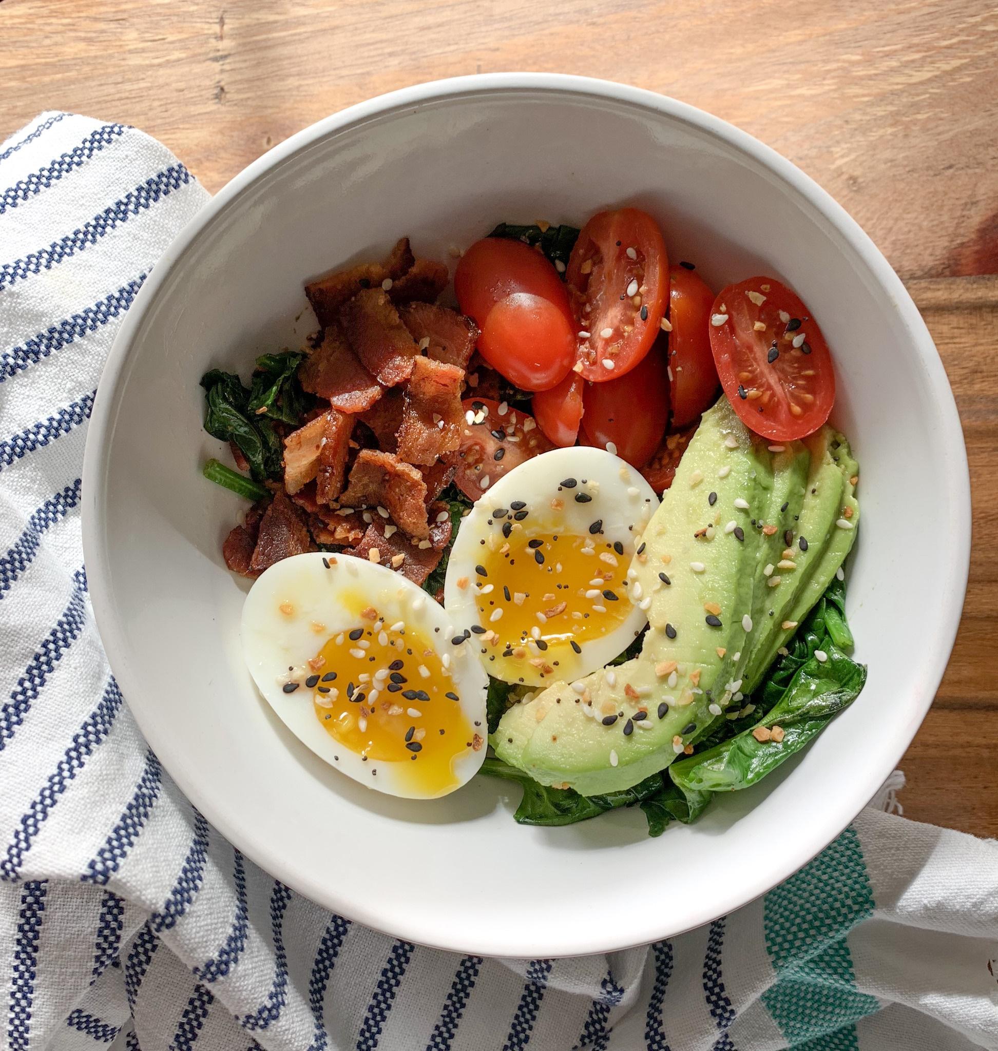My oil free breakfast bowl contains sauteed spinach, half boiled egg