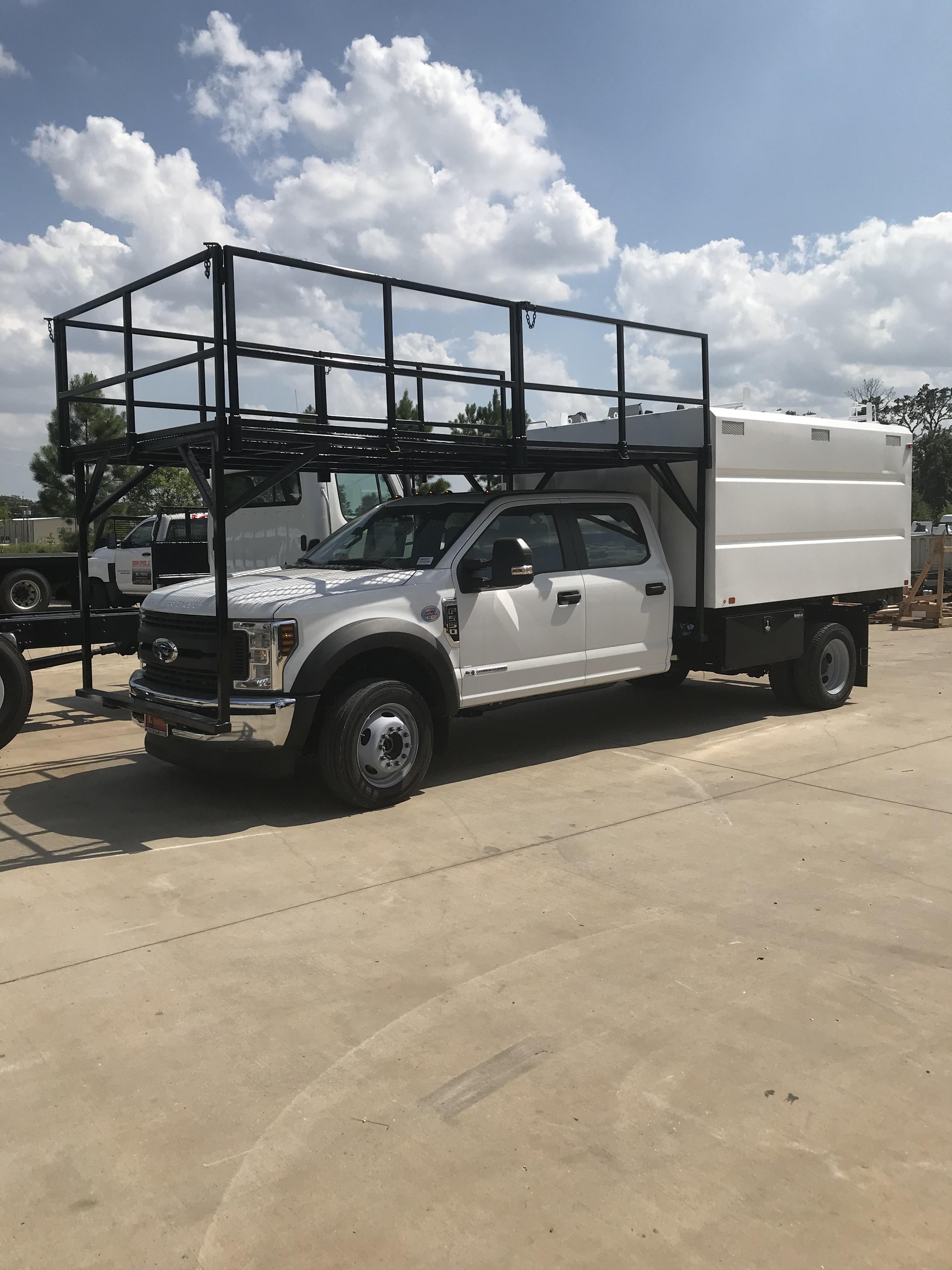 2020 F350 upfitted with chipper body, rugby hoist and custom cab over