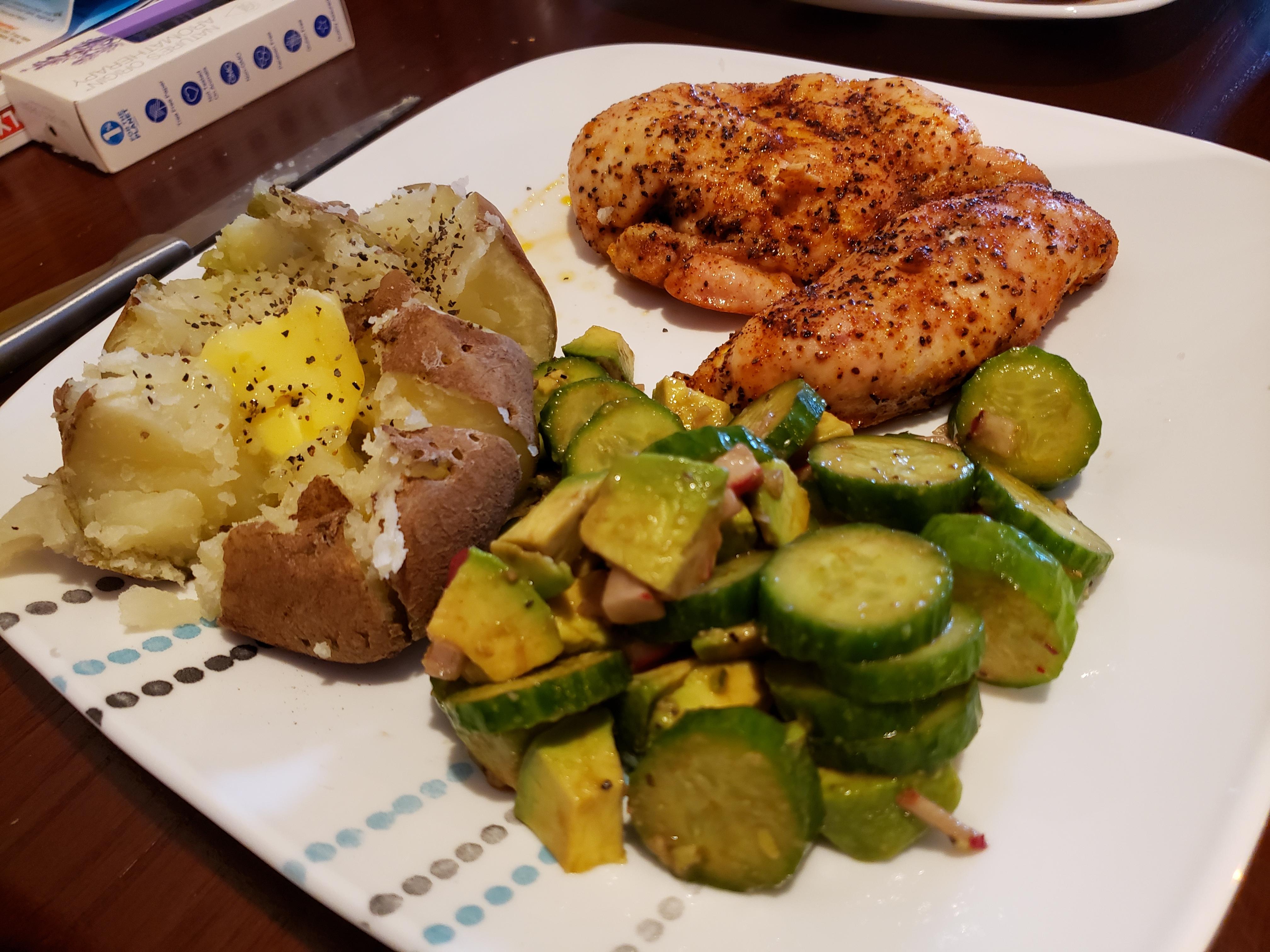 Baked chicken breast, baked potato, and a cucumber salad! r