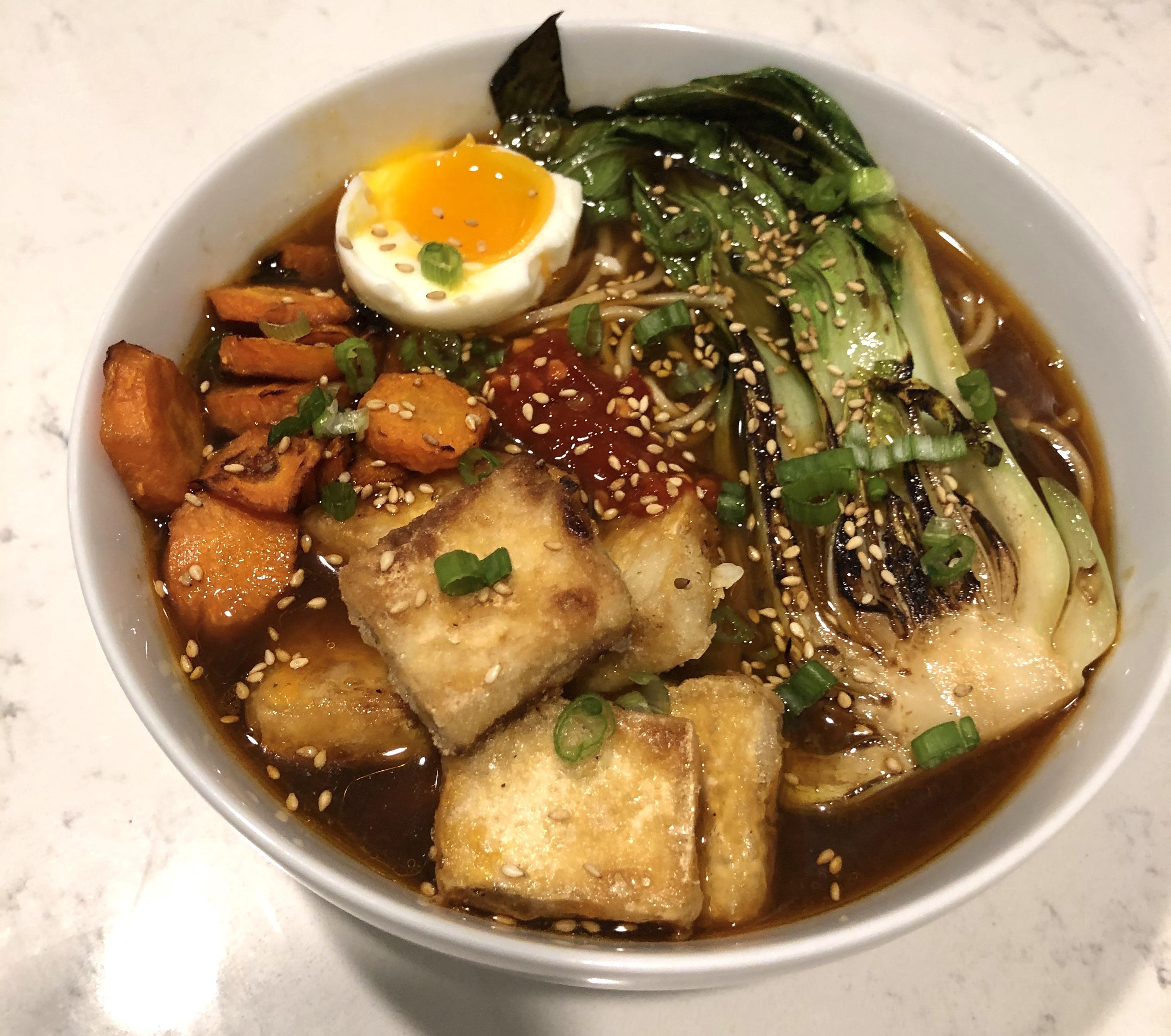 Ramen with crispy tofu, glazed carrots, soft boiled egg, and seared