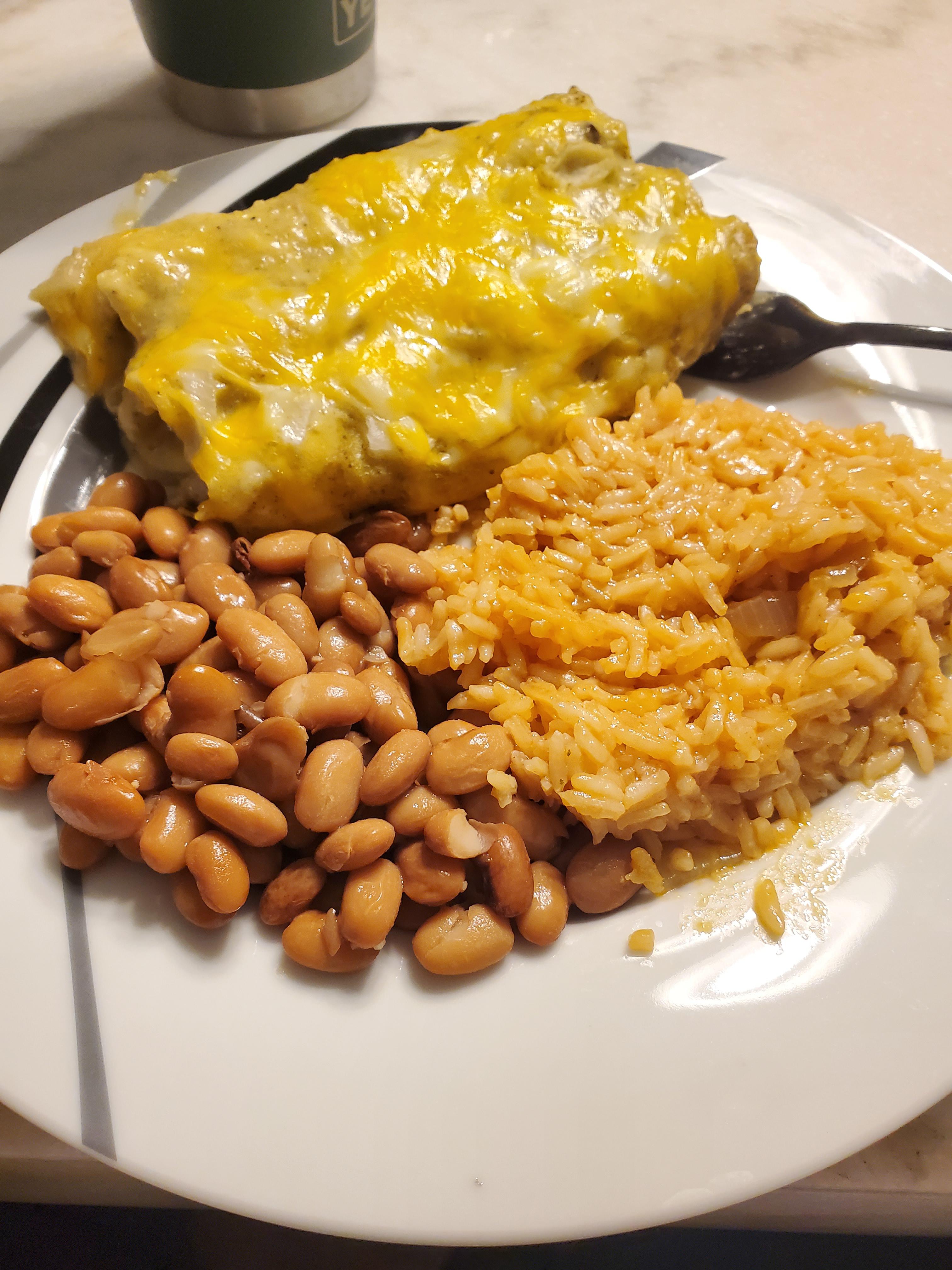 Homemade green chile chicken enchiladas, rice, and pinto beans. r