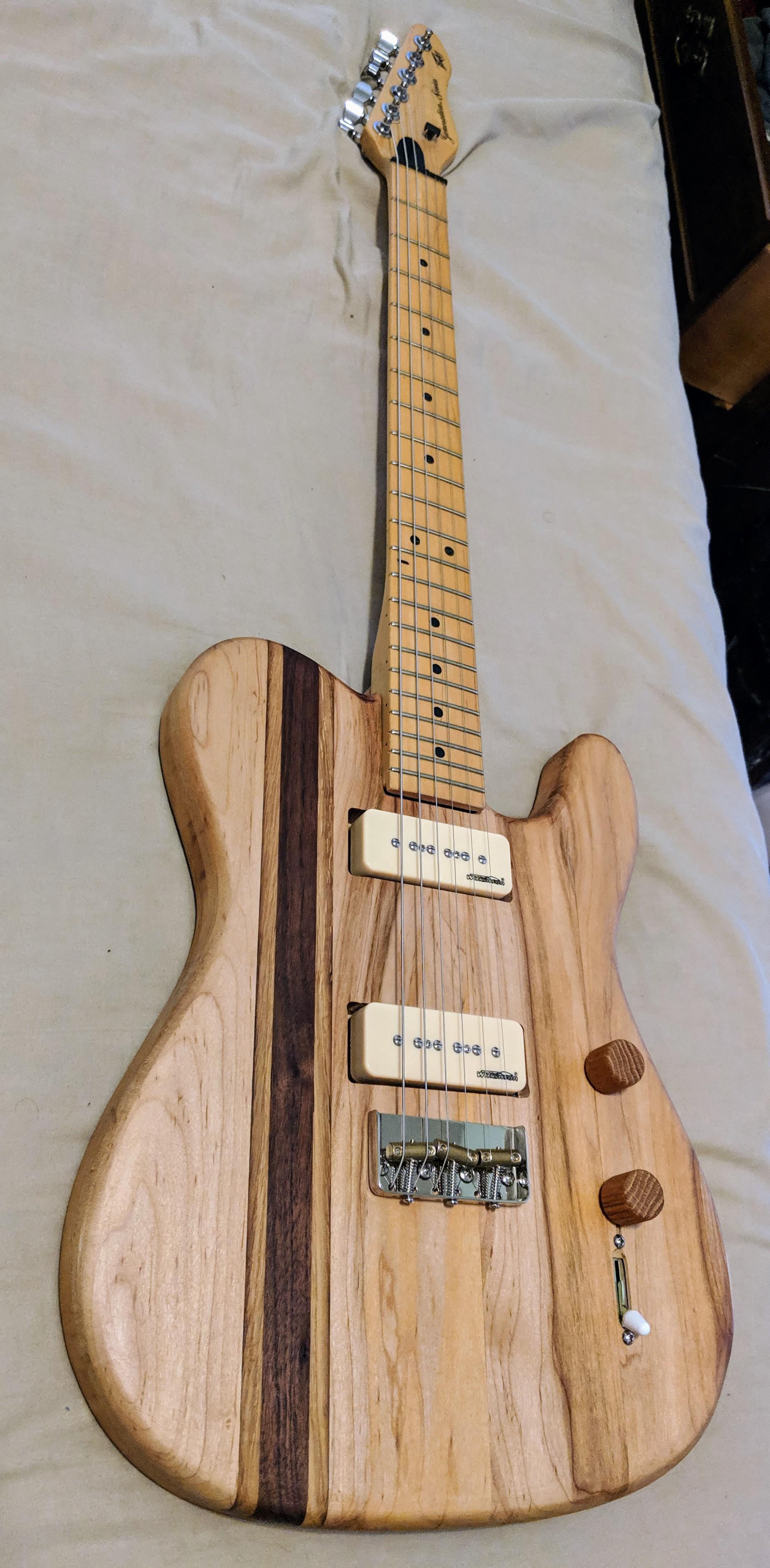 Guitar body I made from maple, oak, and walnut. Made a lot mistakes but