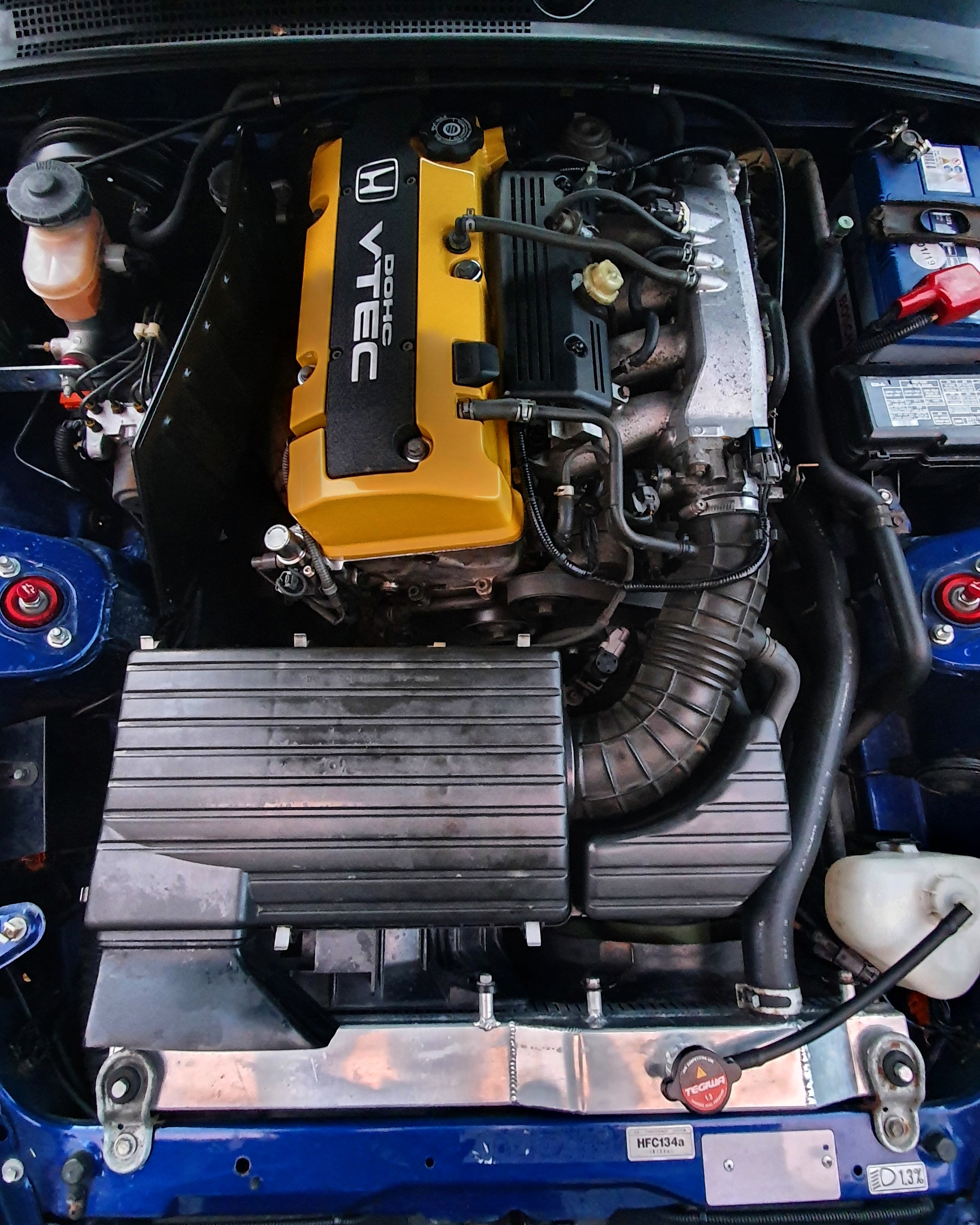 Freshly painted rocker cover in, along with new spark plugs and a valve