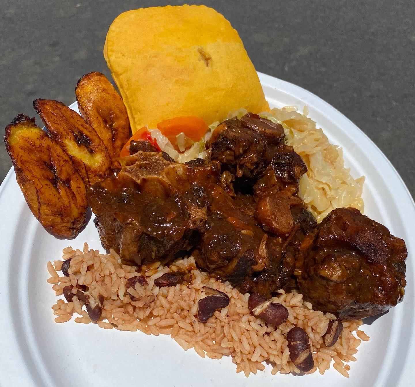 Oxtail Stew and a Beef Patty with Sweet Plantains and Cabbage on Rice