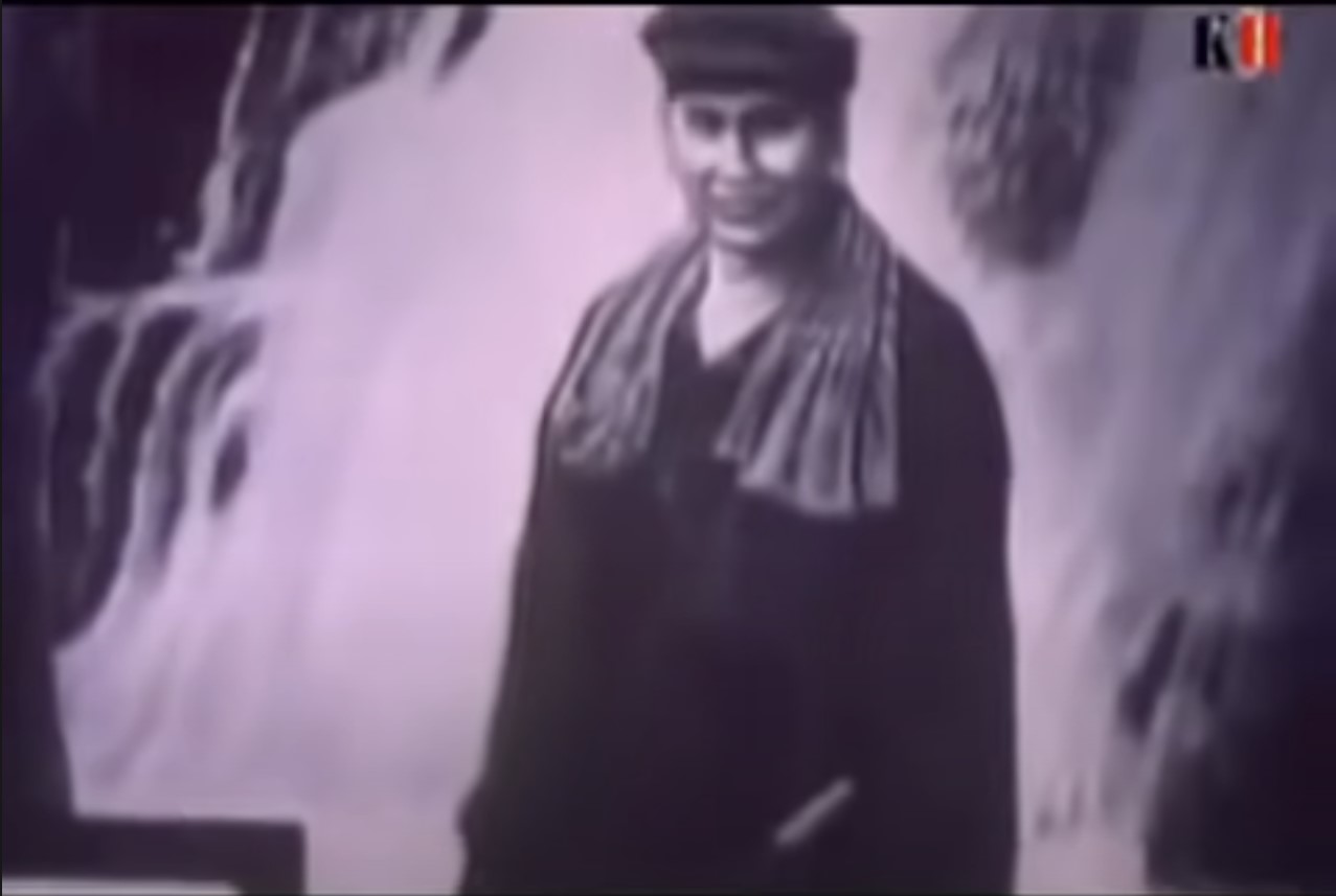 A portrait of Pol Pot standing behind a waterfall. This was during the