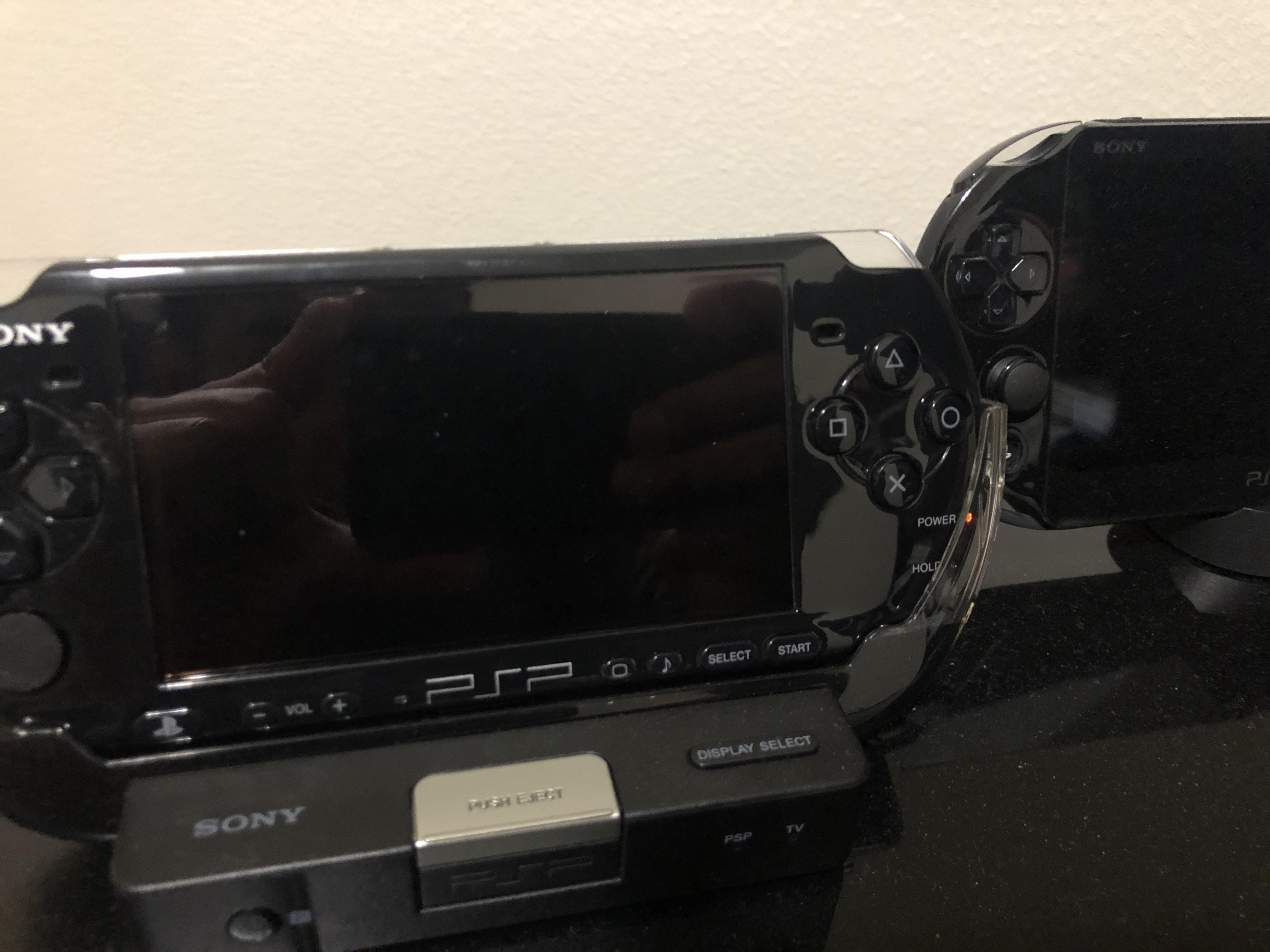 PSP 3000 with official 3000 cradle along with Vita 2000 with official