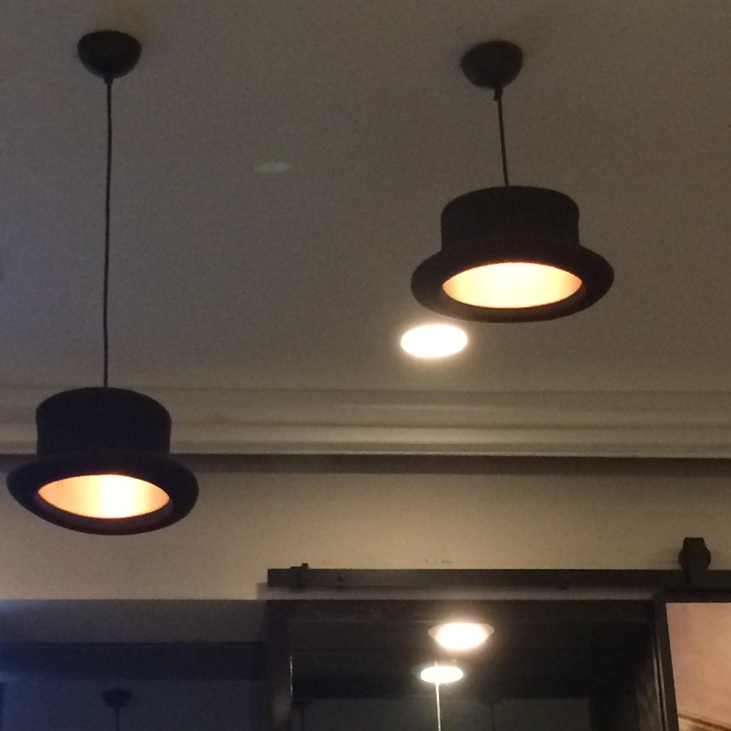 These light fixtures at my hotel bar are top hats. r/mildlyinteresting