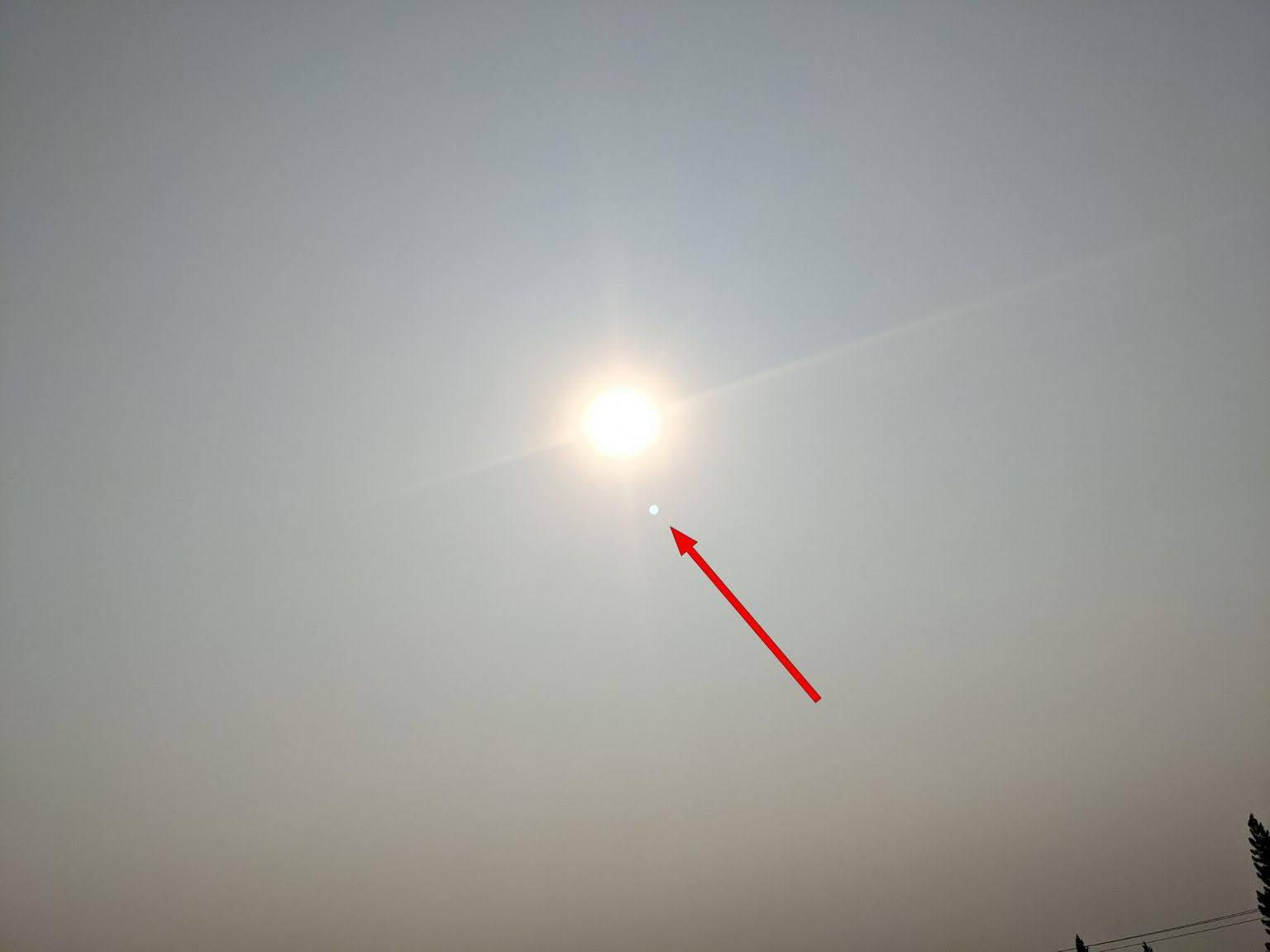 Venus. Smoke acts like a filter making it easier to photograph the Venus in the